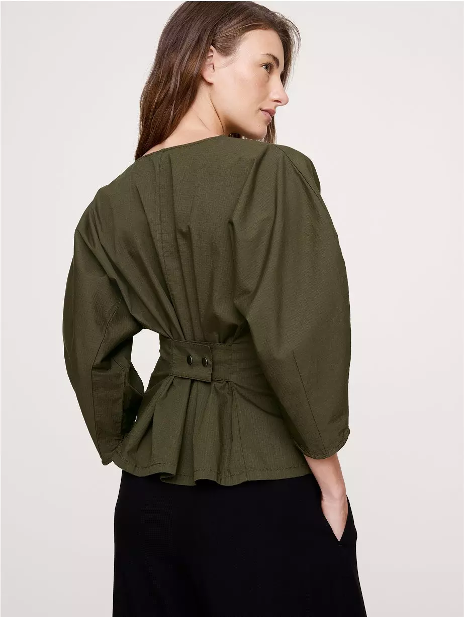 Woman in a dark green blouse