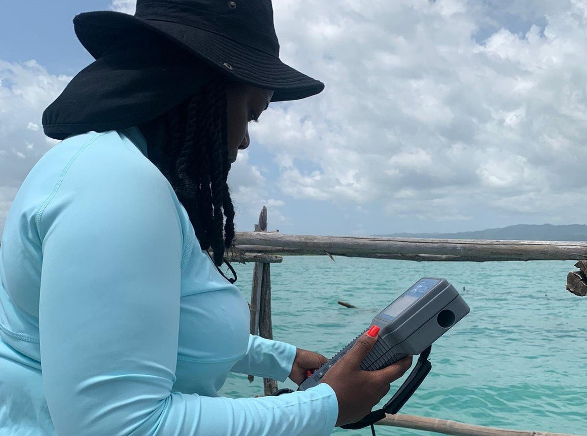 Woman monmitoring water parameters in the ocean