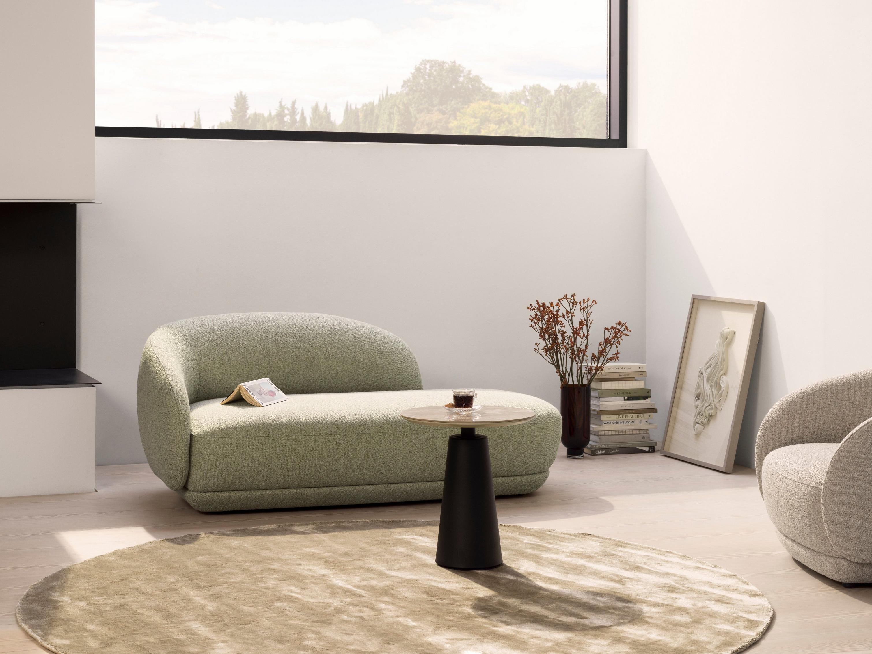 Relaxing living room with the Bolzano chaise longue sofa in light green Lazio fabric.