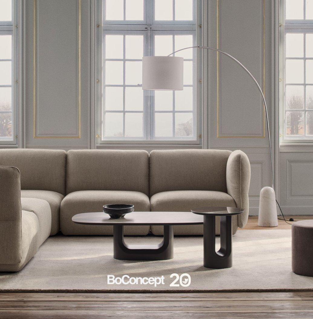BoConcept living room set with modular sofa, low coffee table and arched floor lamp.