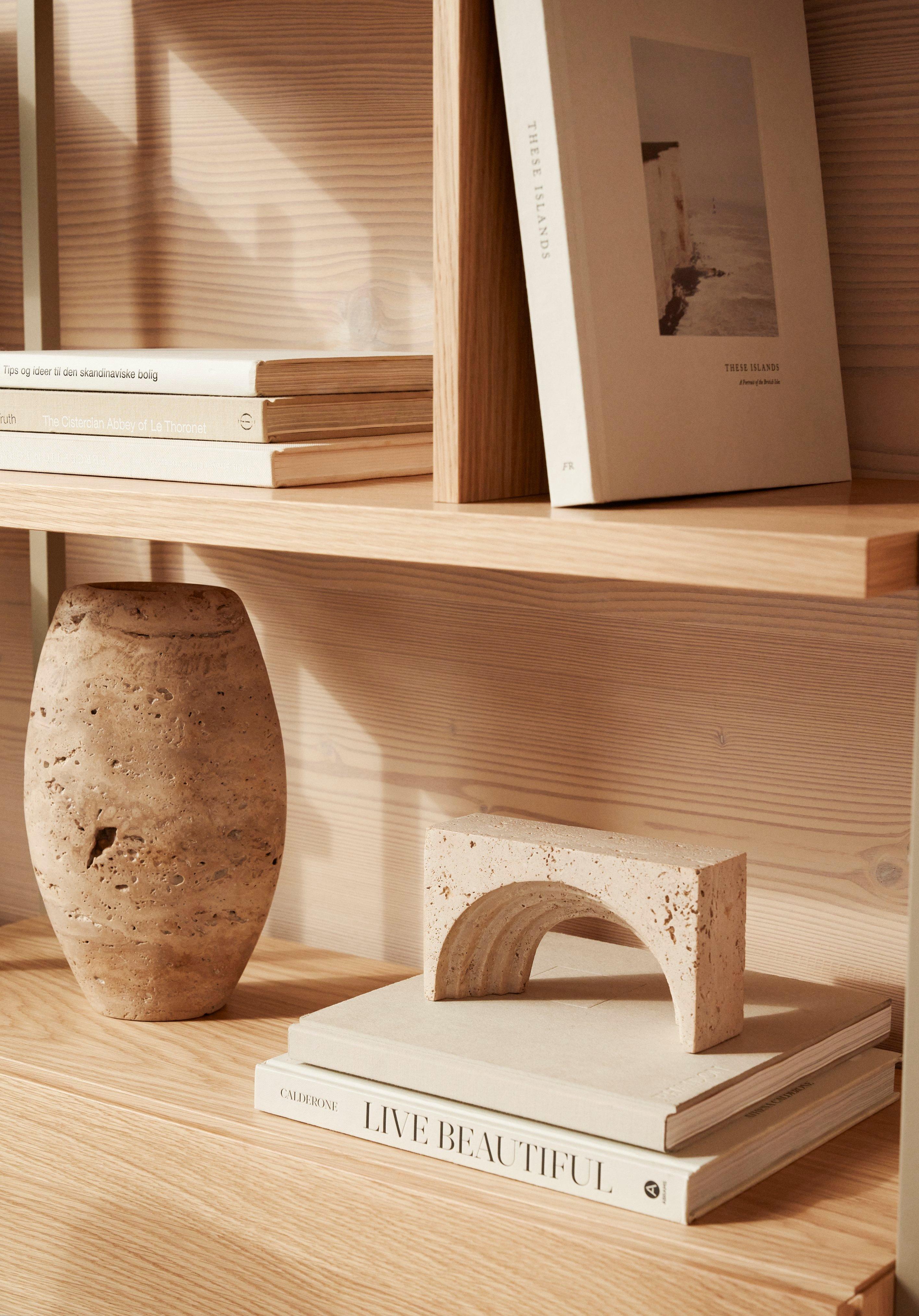 A minimalist display of books and ceramics on the Calgary storage system in Natural Oak.