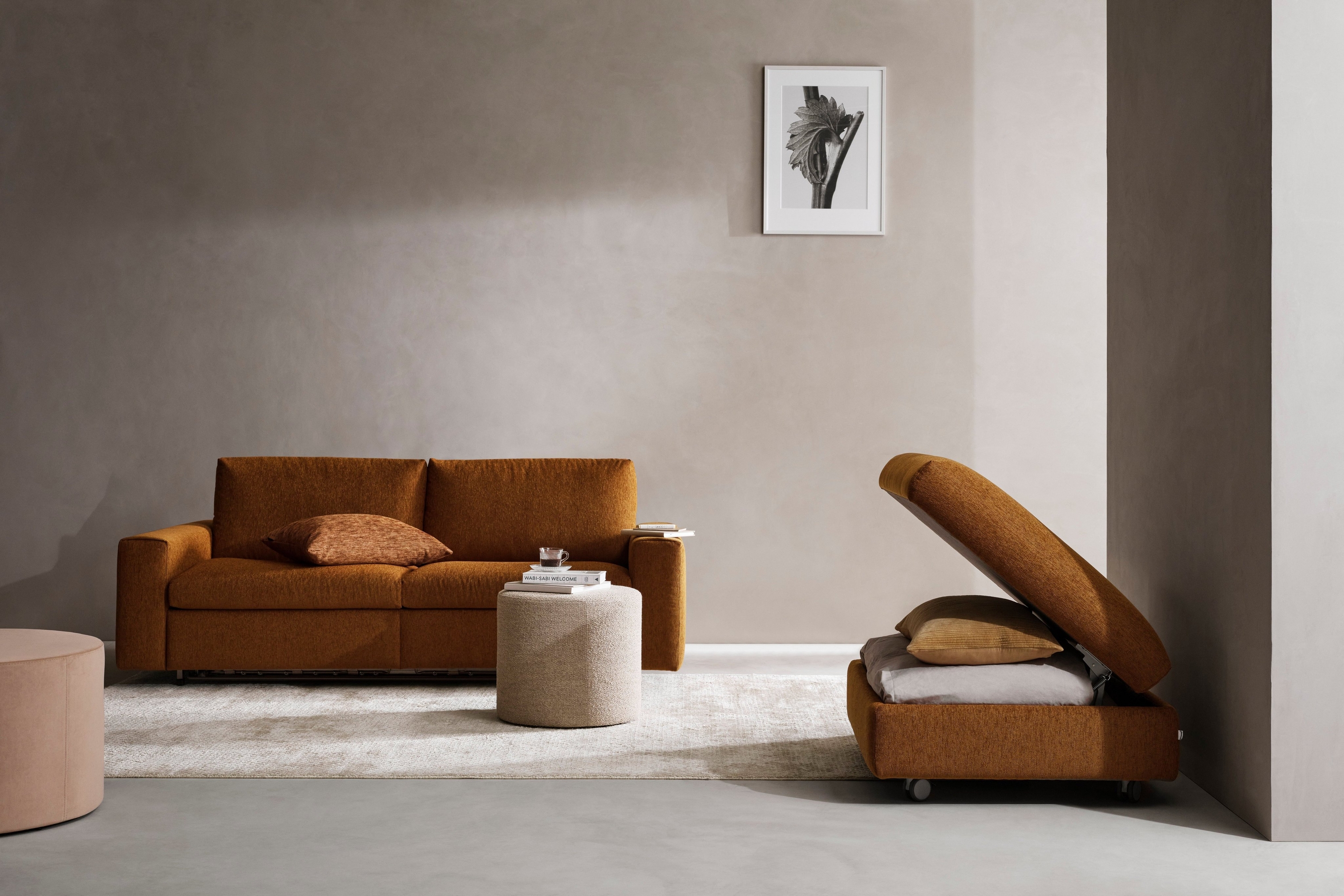 Modern room with a Taylor sofa bed, Taylor storage footstool, and minimalist decor.