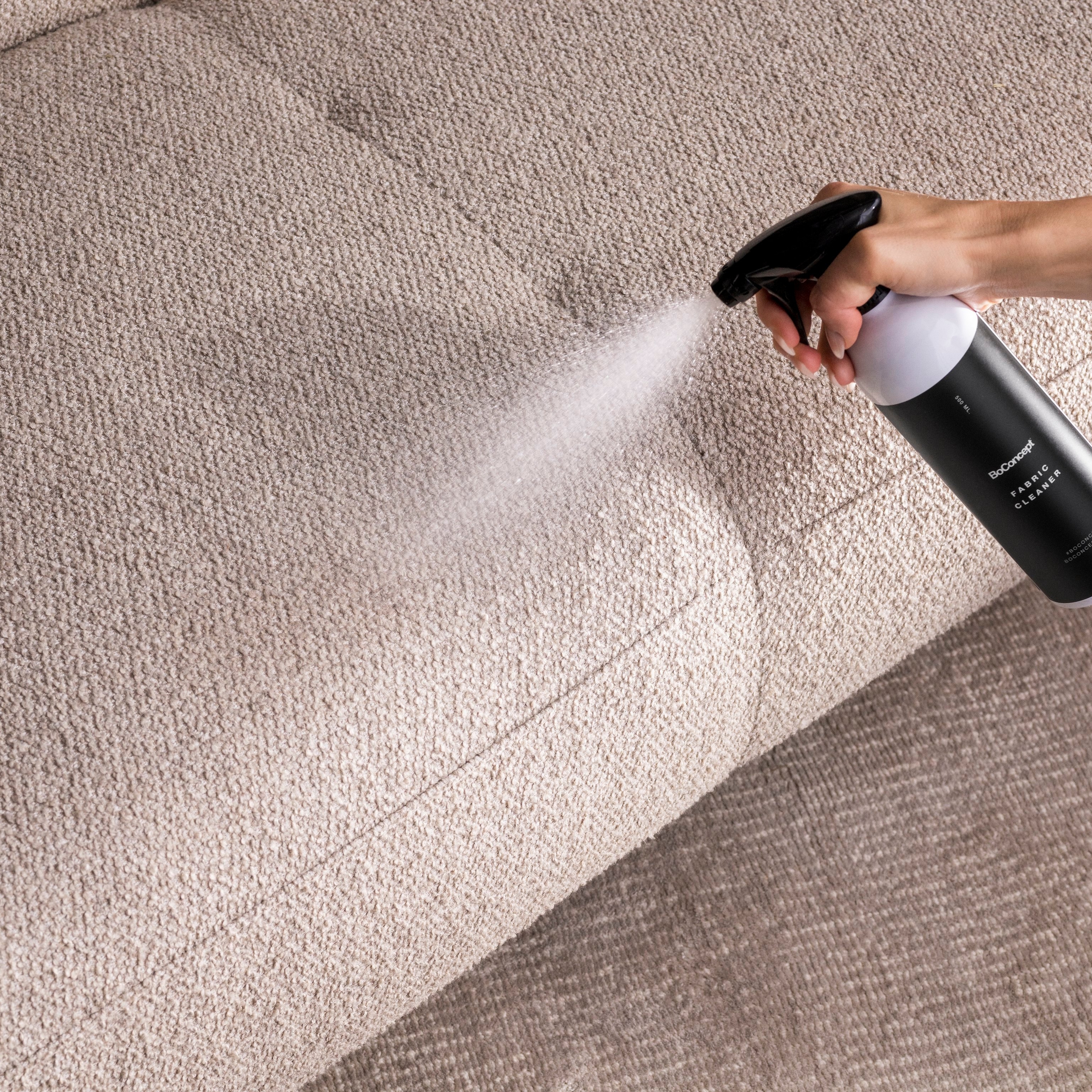 BoConcept fabric care spray applied to a beige surface.