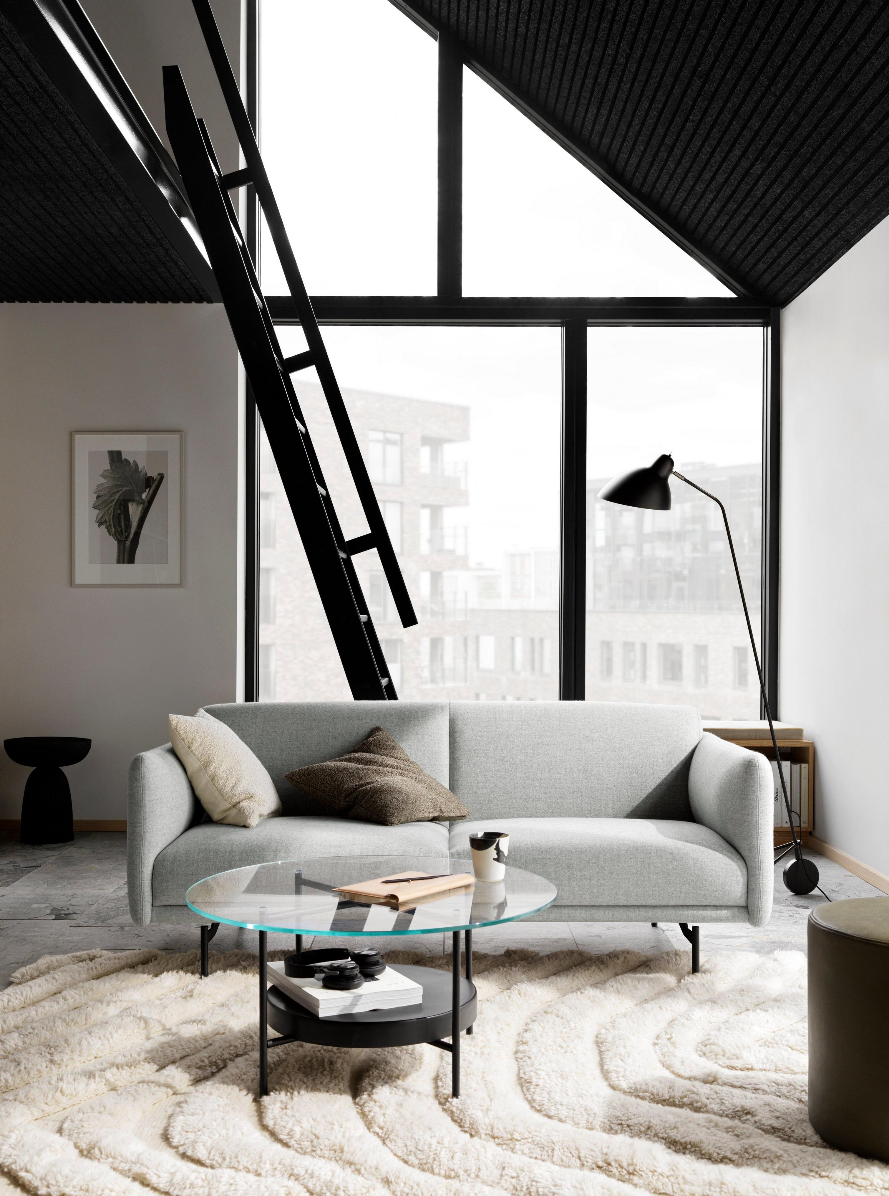 Loft living room with a Berne sofa, Madrid glass coffee table, shag rug, and floor-to-ceiling windows.