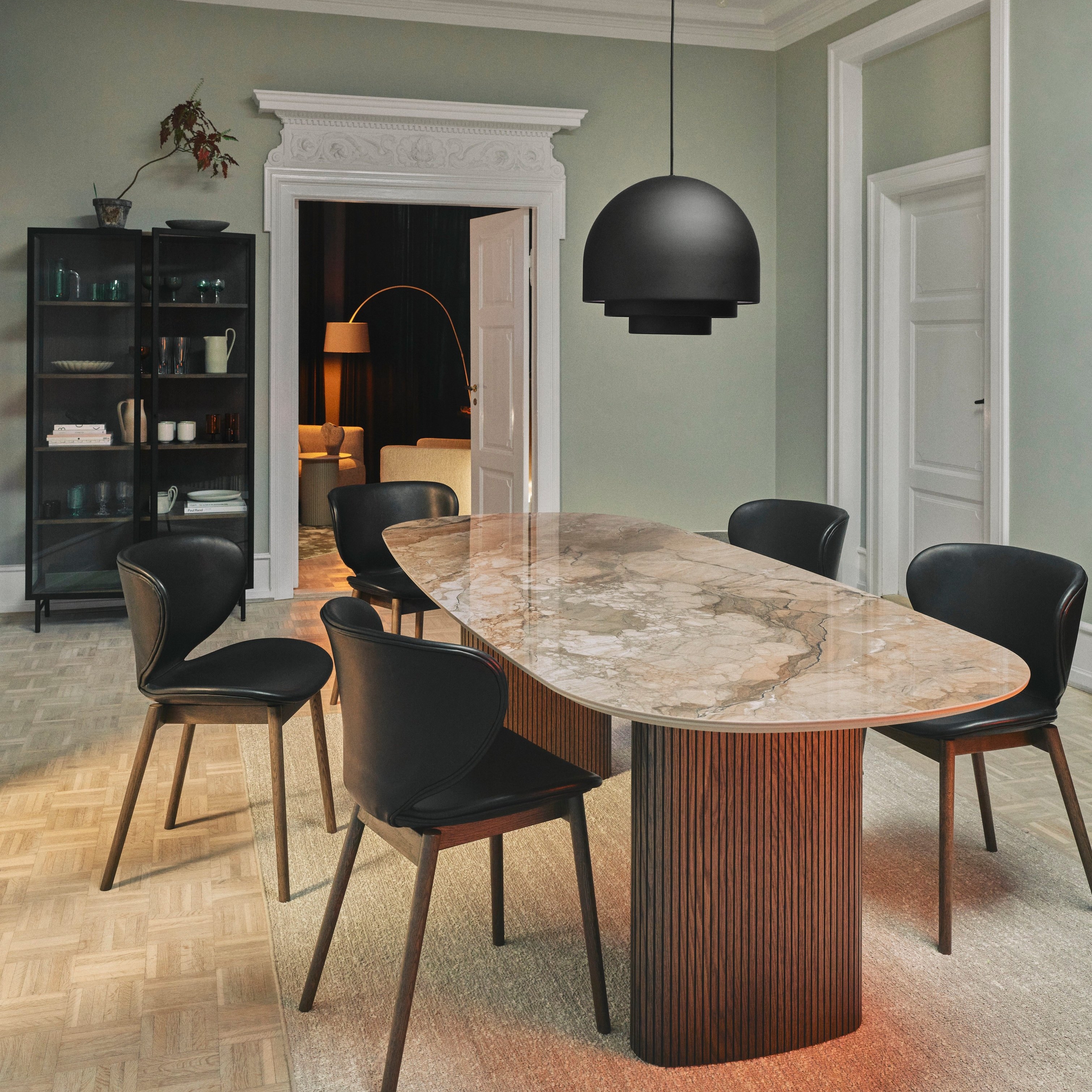 A modern dining room featuring the Santiago dining table and the Hamilton dining chair.