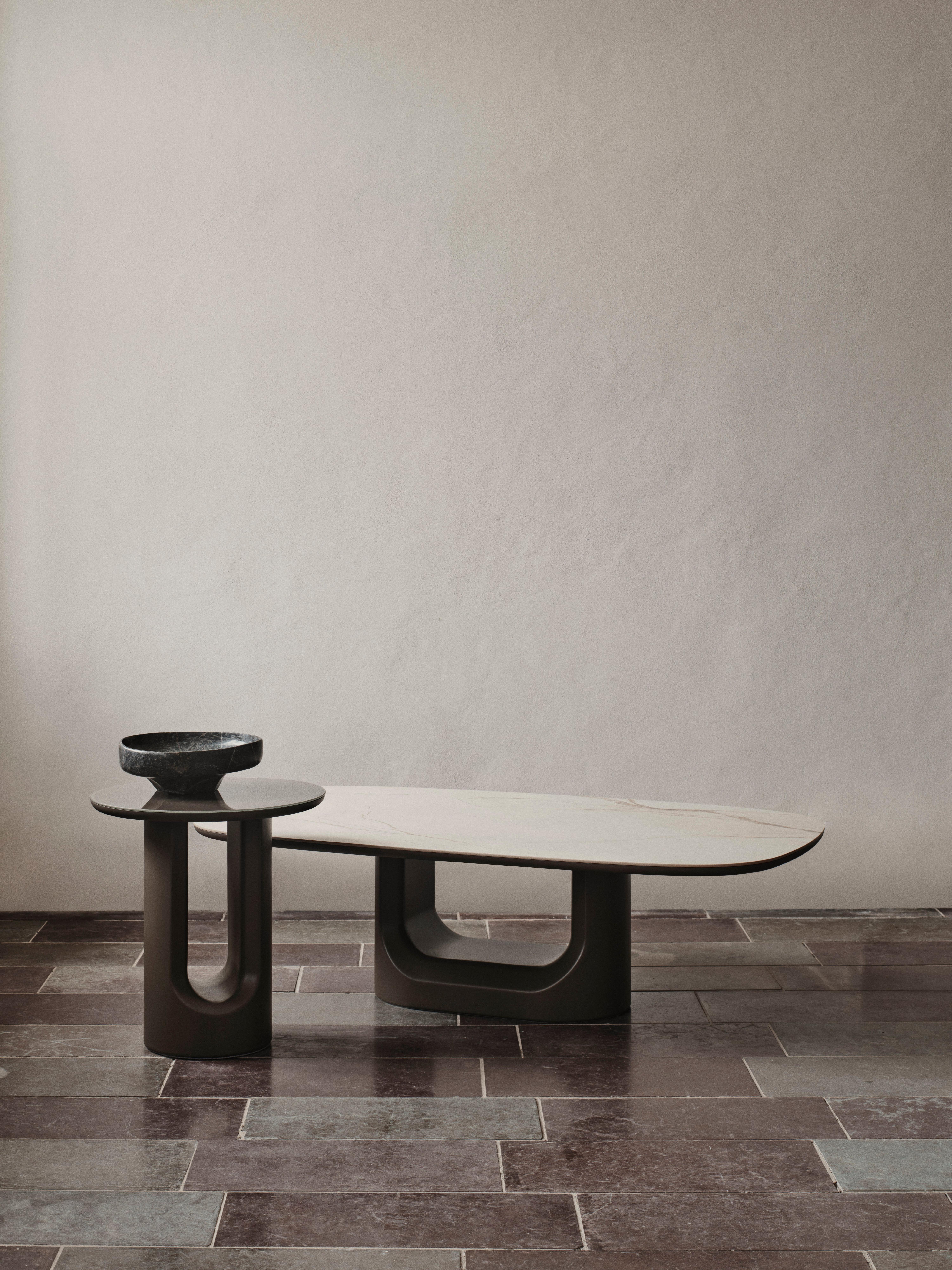 Two modern nesting coffee tables with rounded legs and a marble-effect top.