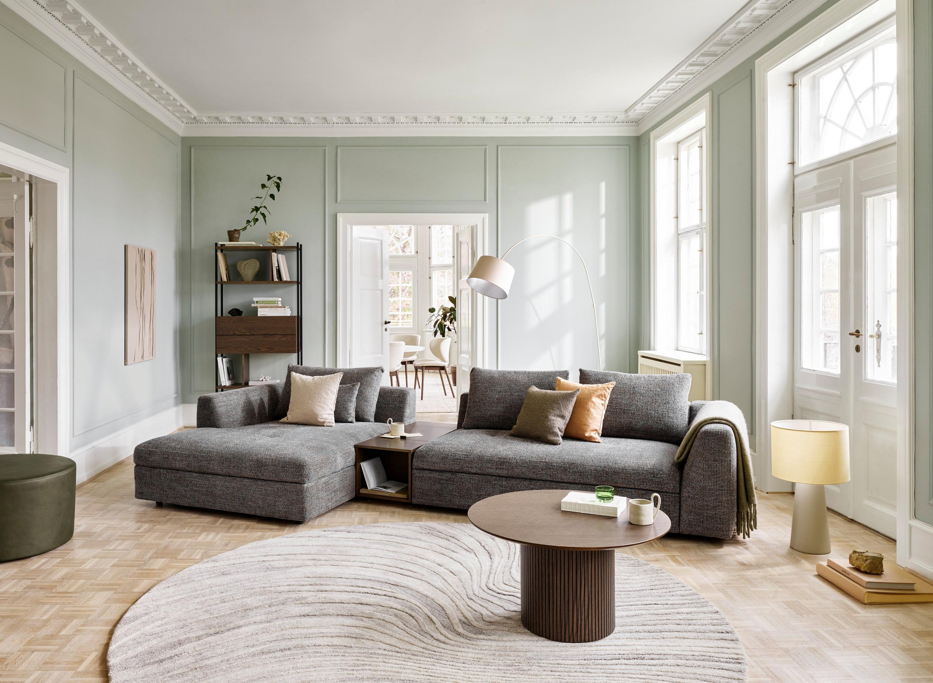 A social living space featuring the Bergamo chaise longue sofa with storage.