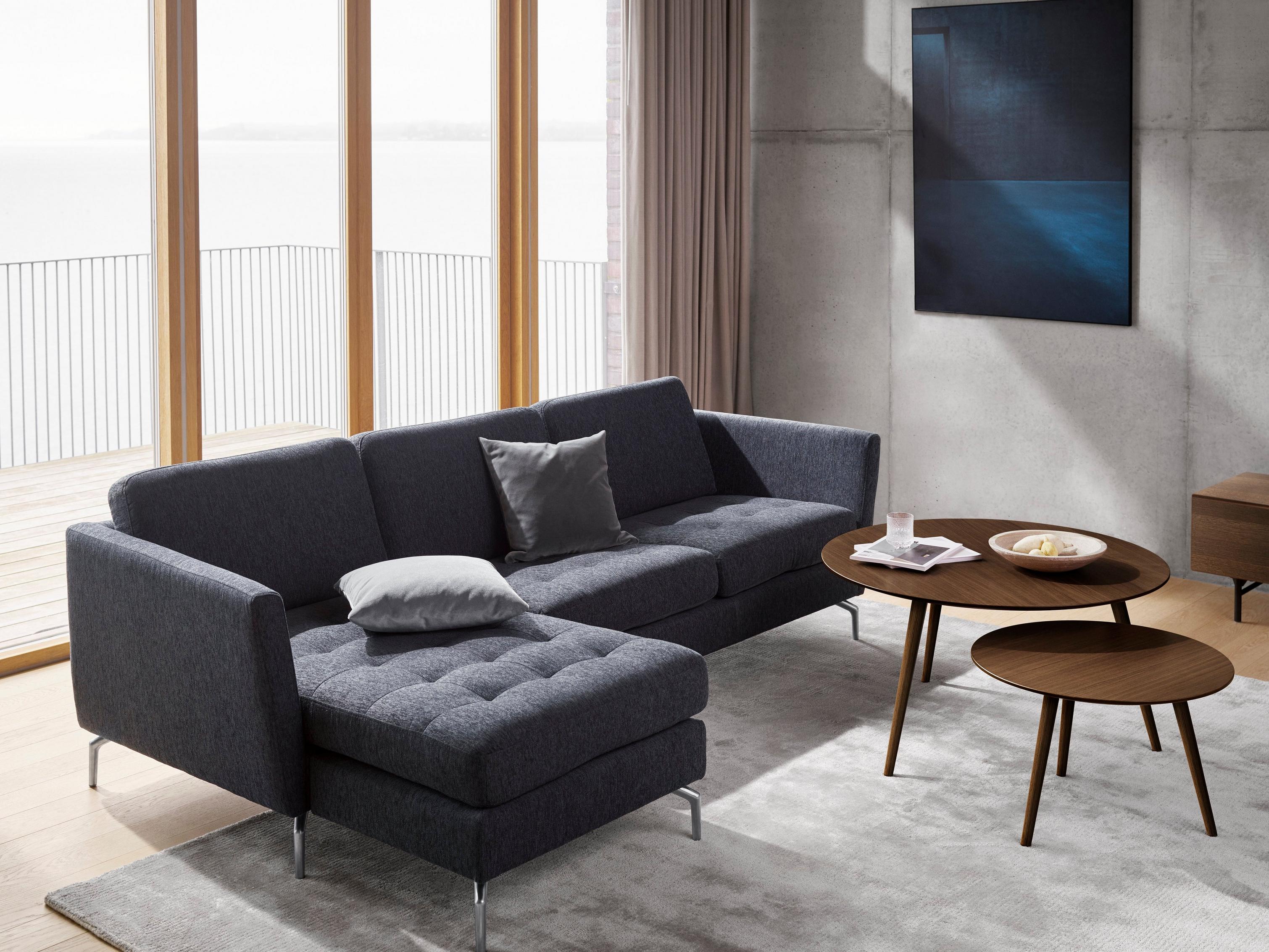 Sala para relajarse con sofá Osaka en tela Bristol color azul y mesas de centro Bornholm en chapa de roble oscuro.
