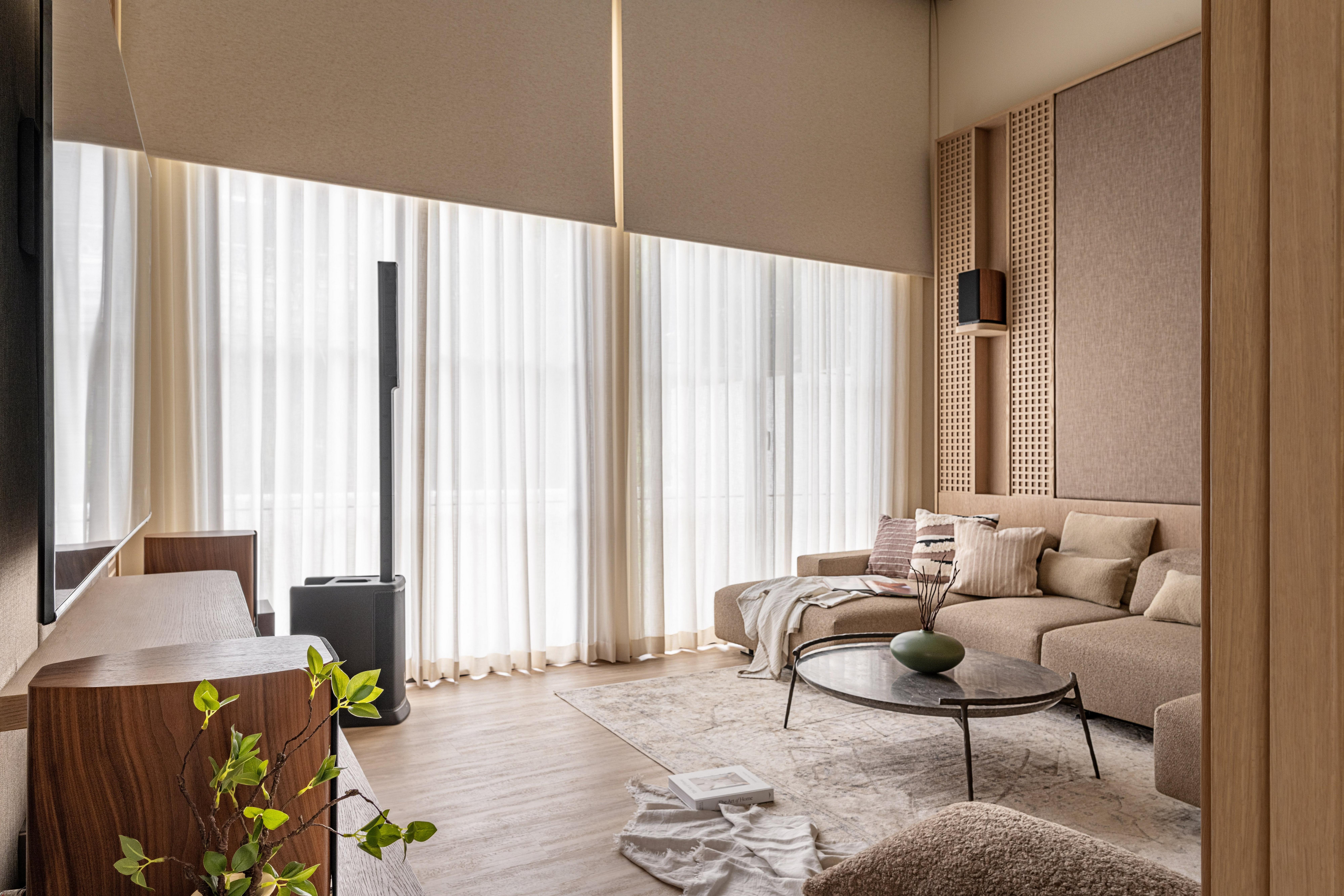 Modern living room with sectional sofa, round coffee table, TV stand and tall air purifier.