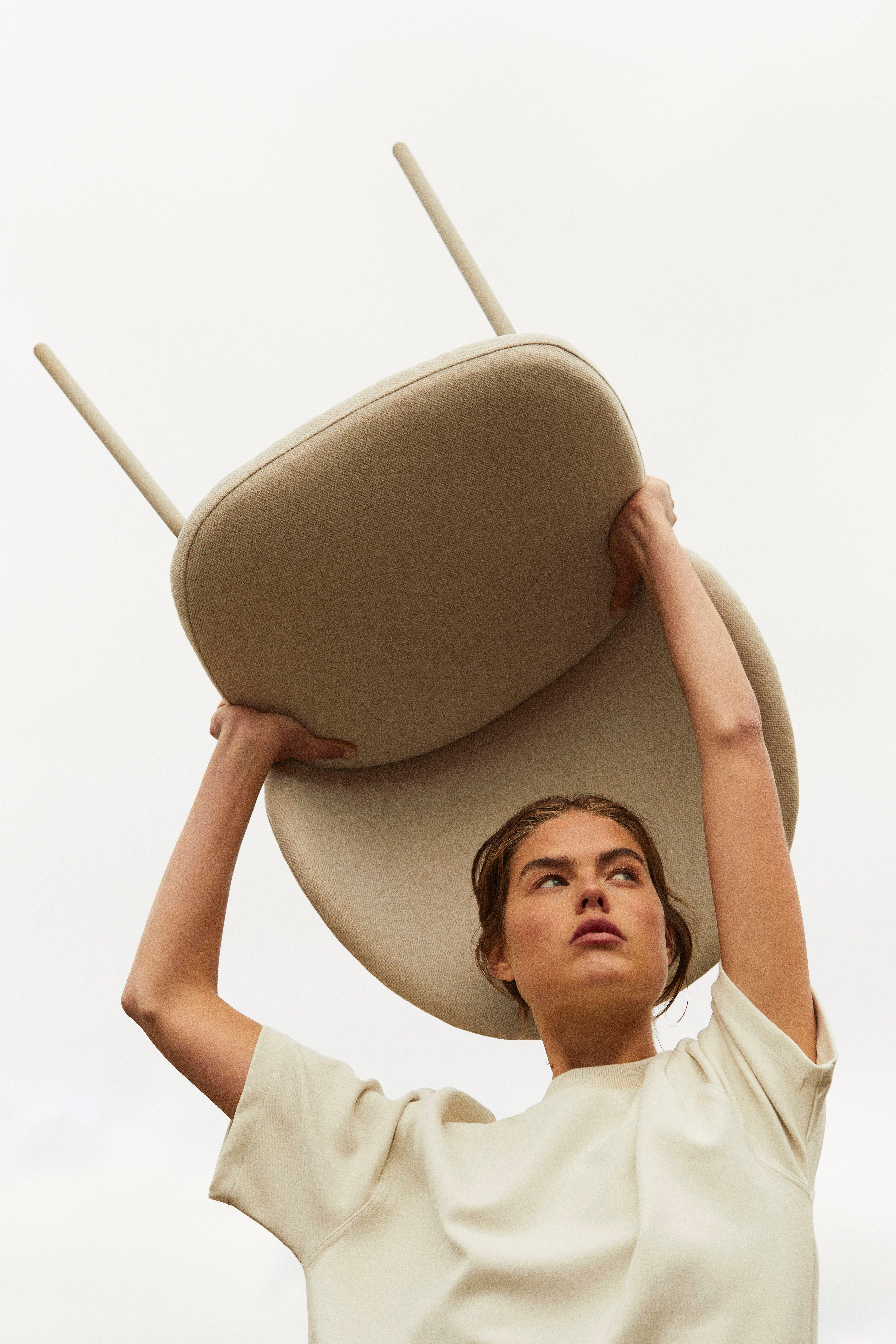 Woman holding the Princeton chair over her head