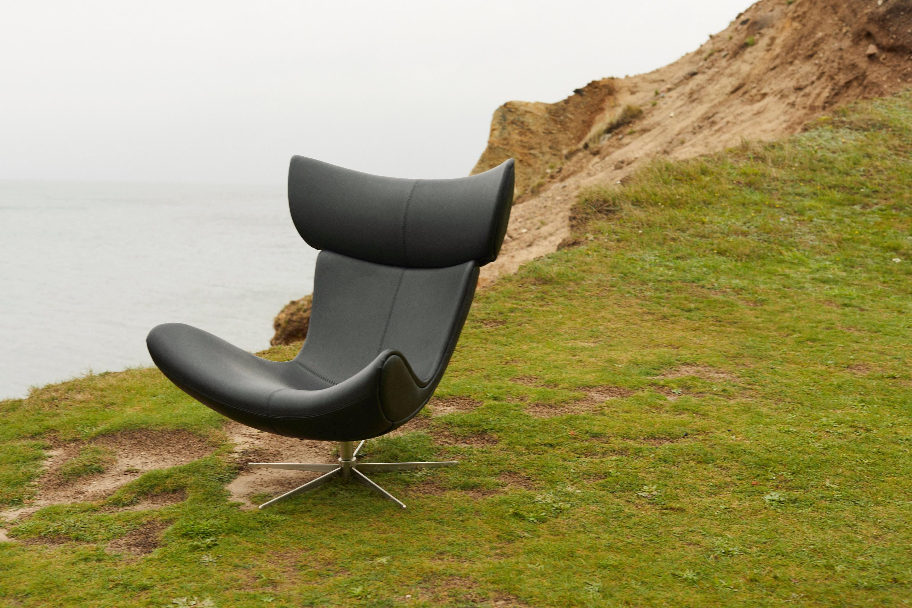 The iconic Imola chair upholstered in black SPOOR Nordic Grain leather alone on a seaside cliff.
