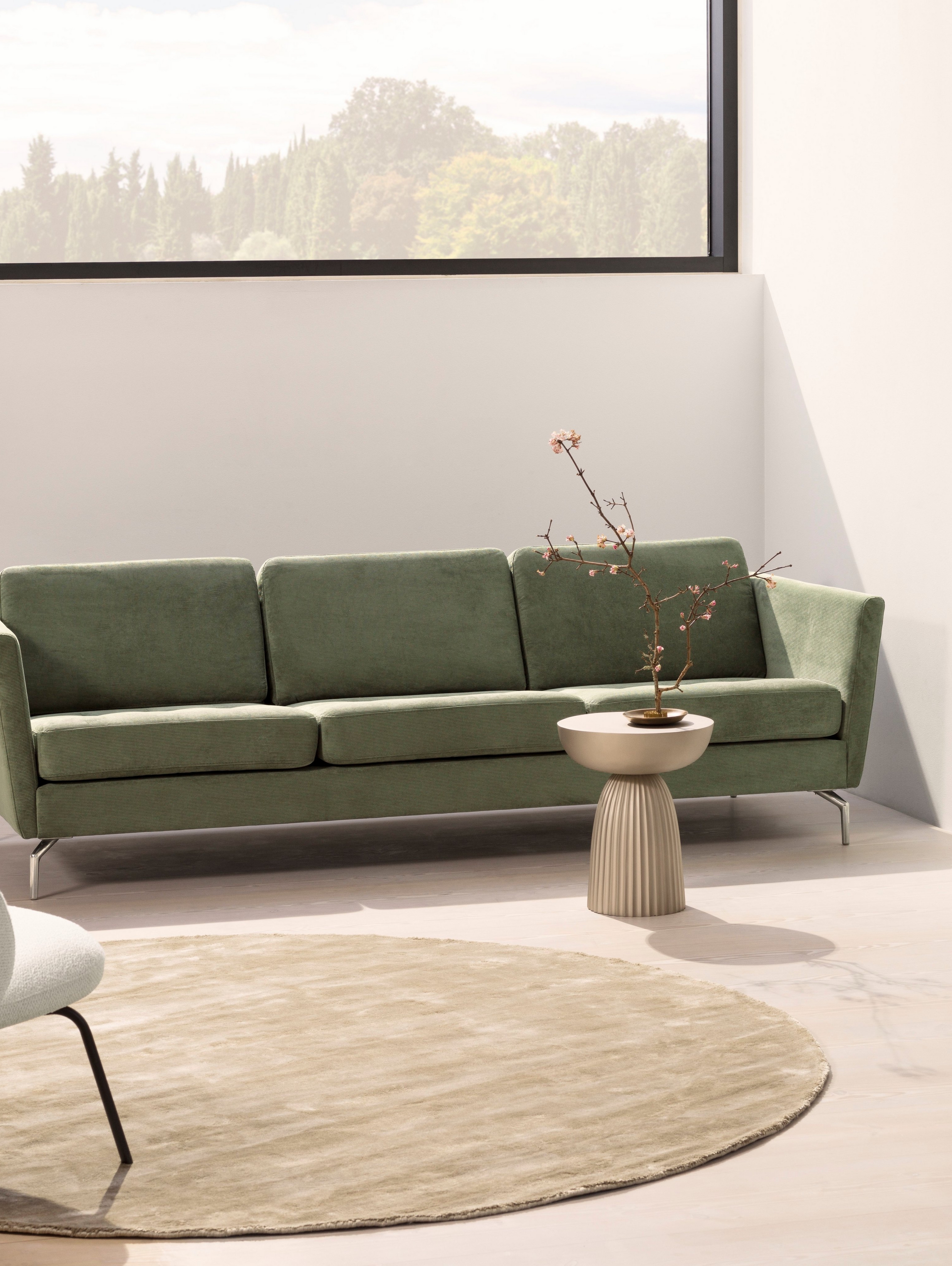 The Osaka sofa with its tufted seats in a living room.