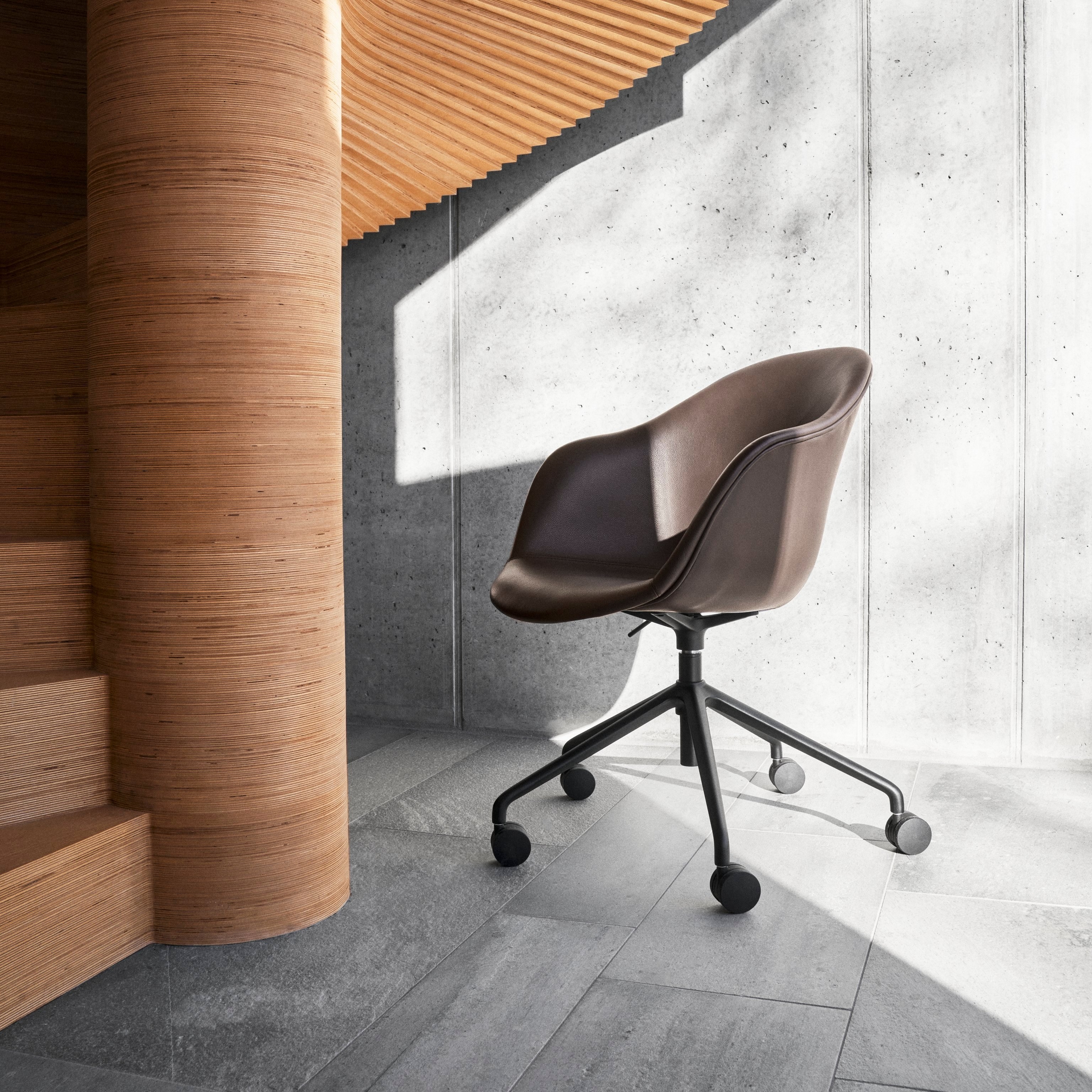 The Adelaide office chair styled next to a spiral staircase