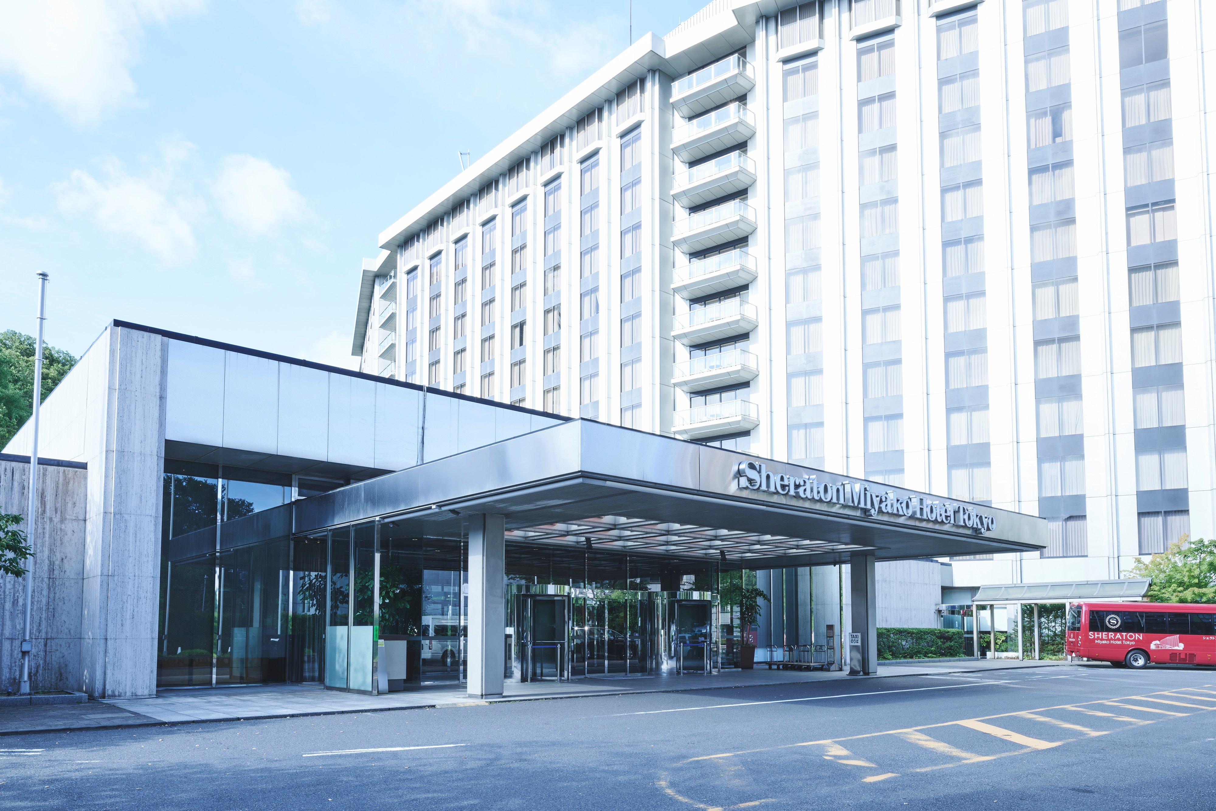 Entrance canopy of Sheraton Miyako Hotel Tokyo with glass doors and high-rise façade.