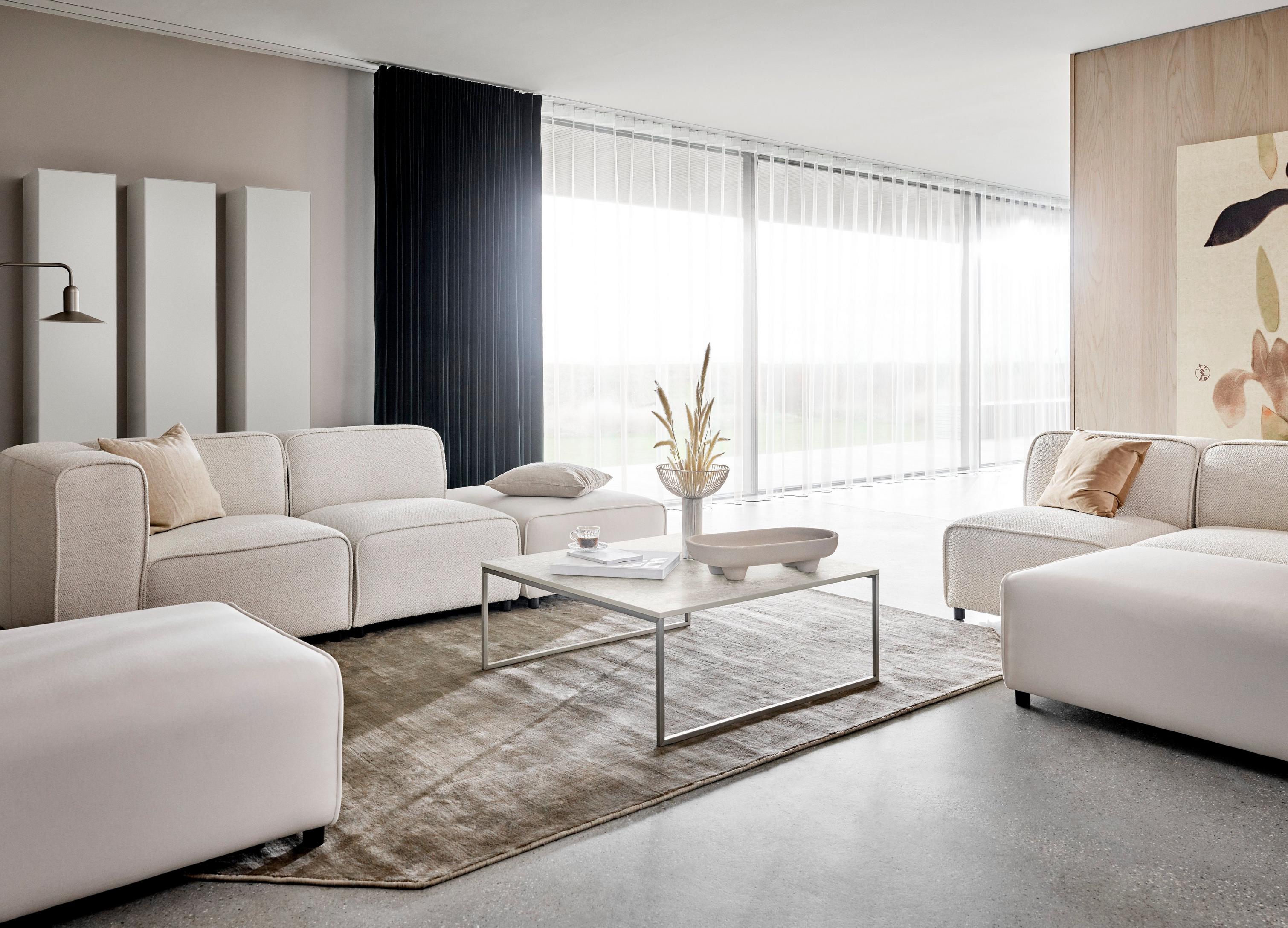 Carmo sofa with lounging unit, carmo footstool in a white Lazio fabric with the Lugo coffee table.