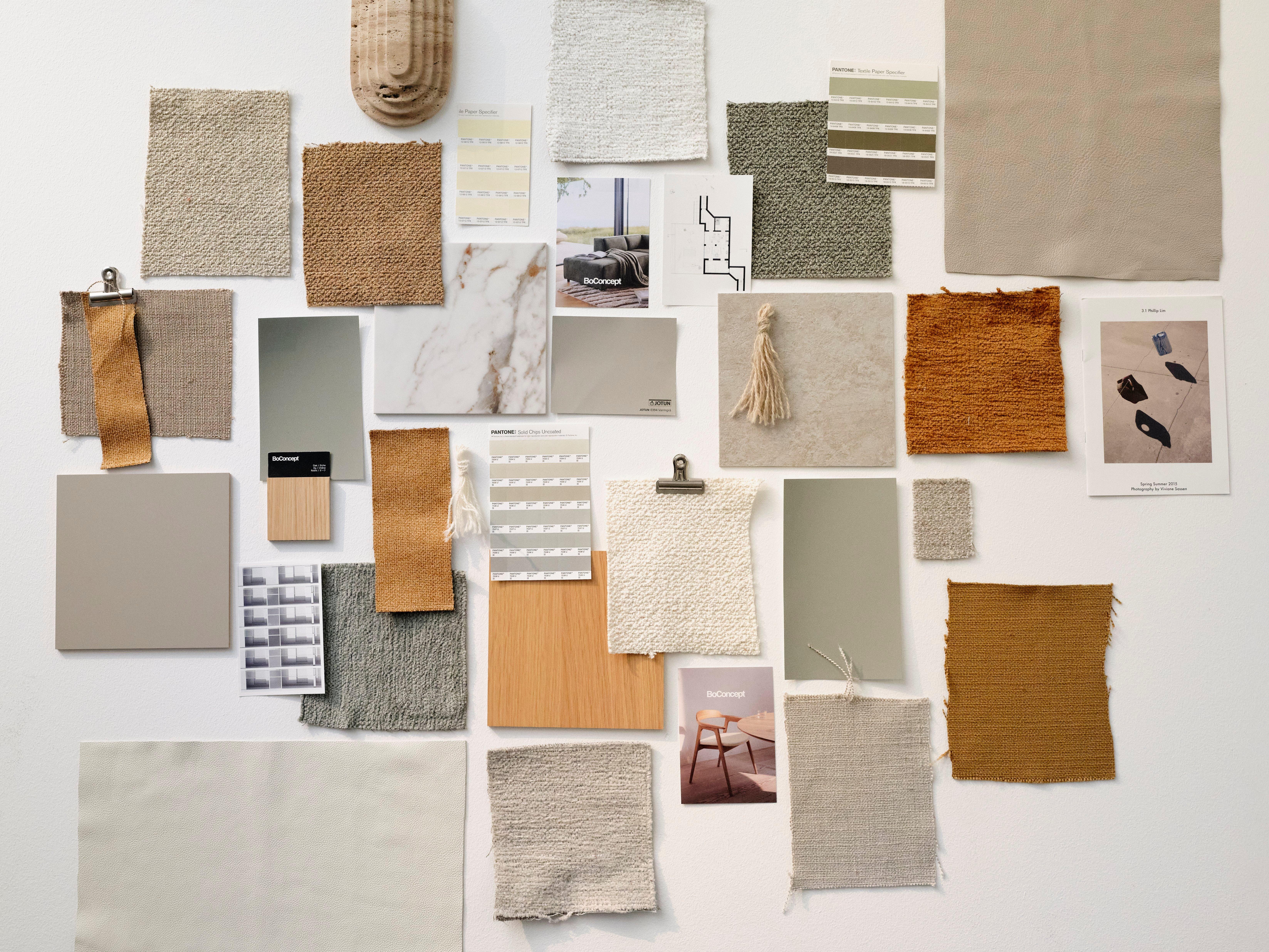 Neutral-toned mood board featuring fabric swatches, paint chips, wood samples, and interior design photos on a white wall.