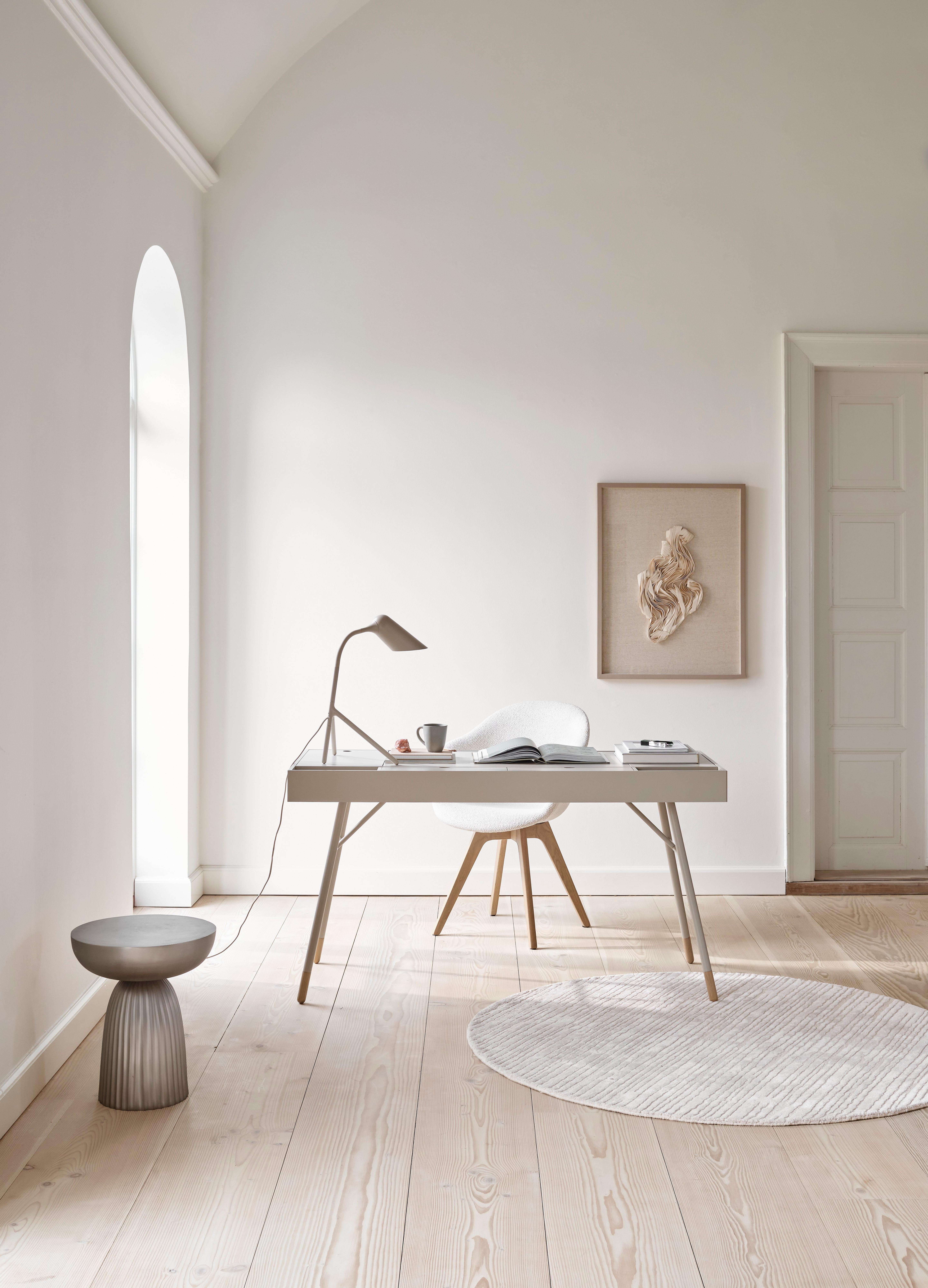 Minimalist interior with the Cupertino desk, Adelaide chair, table lamp, stool, oval rug, and wall art.