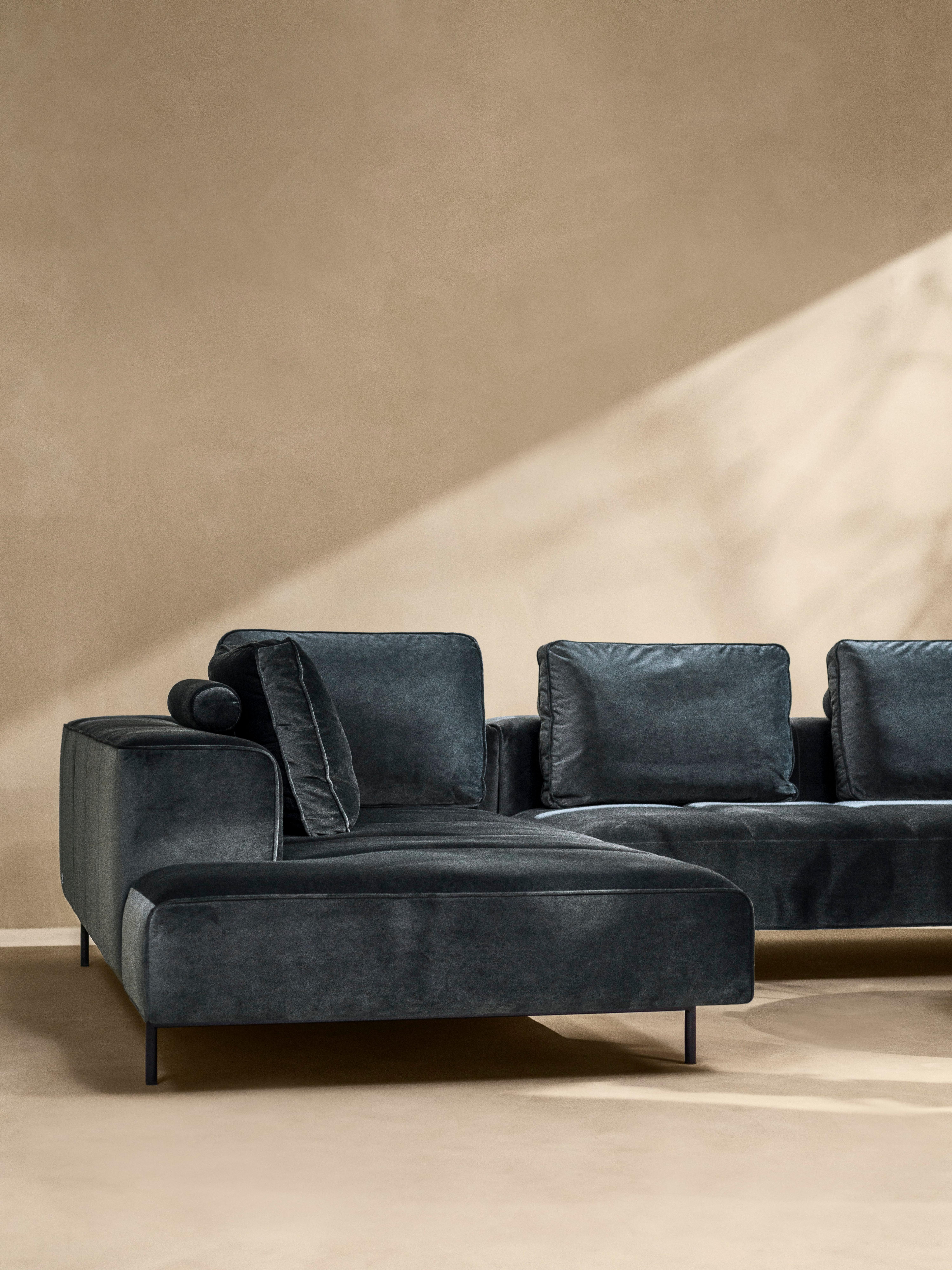 Clean living room featuring the Amsterdam corner sofa in dusty green Velvet fabric.