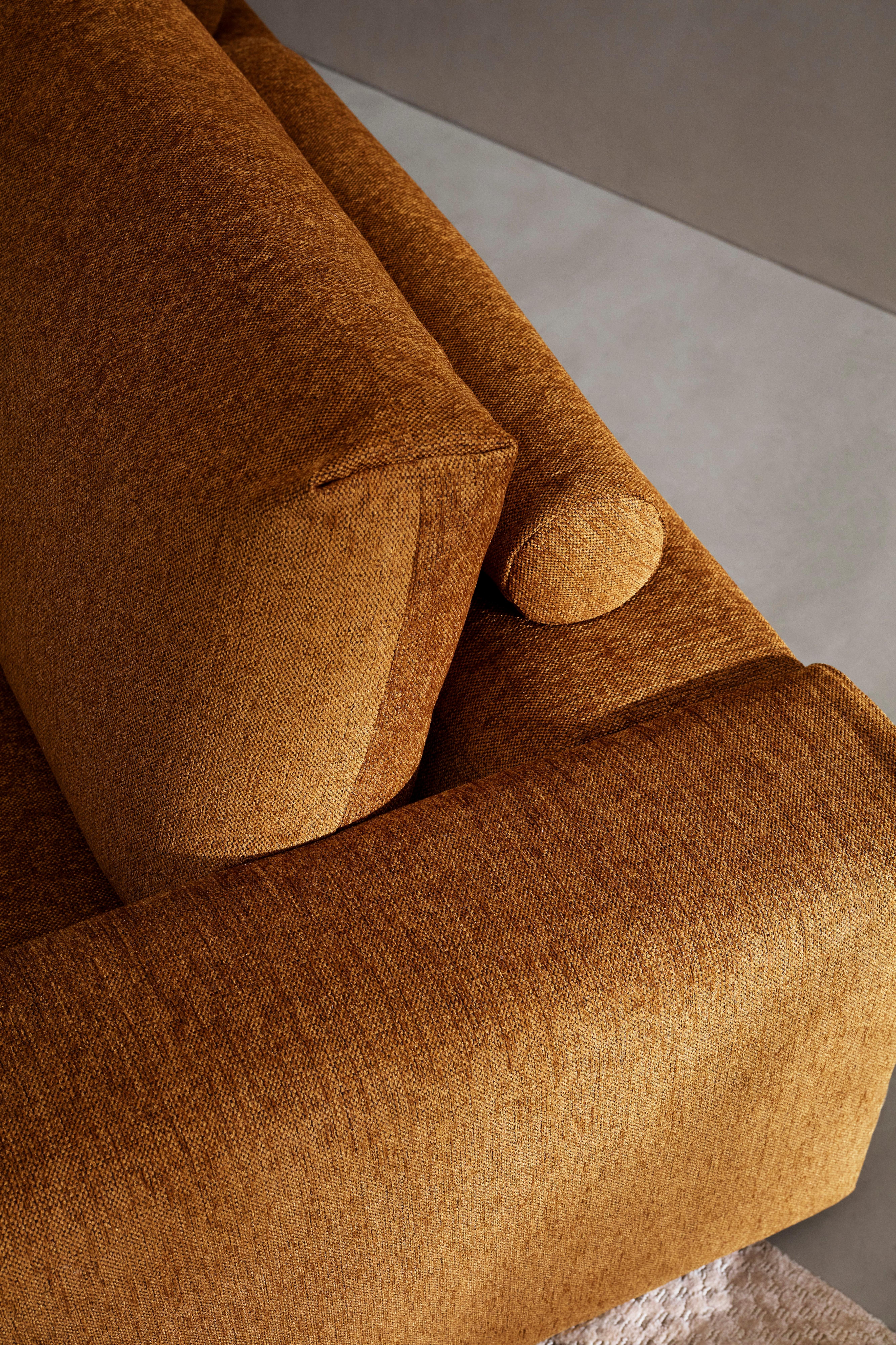 Close-up of Taylor sofa with textured upholstery and plush cushion.