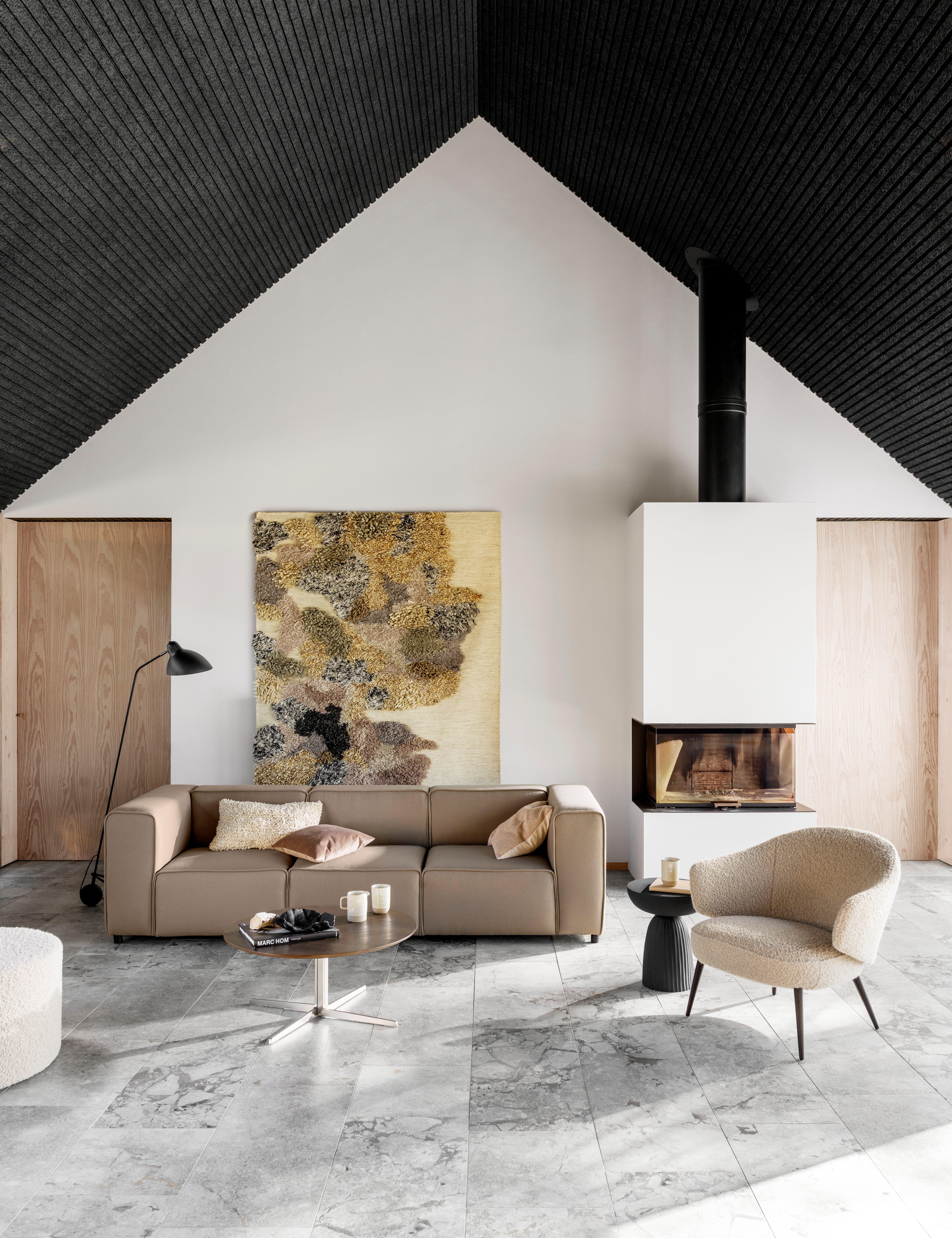 Carmo sofa placed in a modern Scandinavian inspired living room, with the Charlotte chair and the Sevilla coffee table.