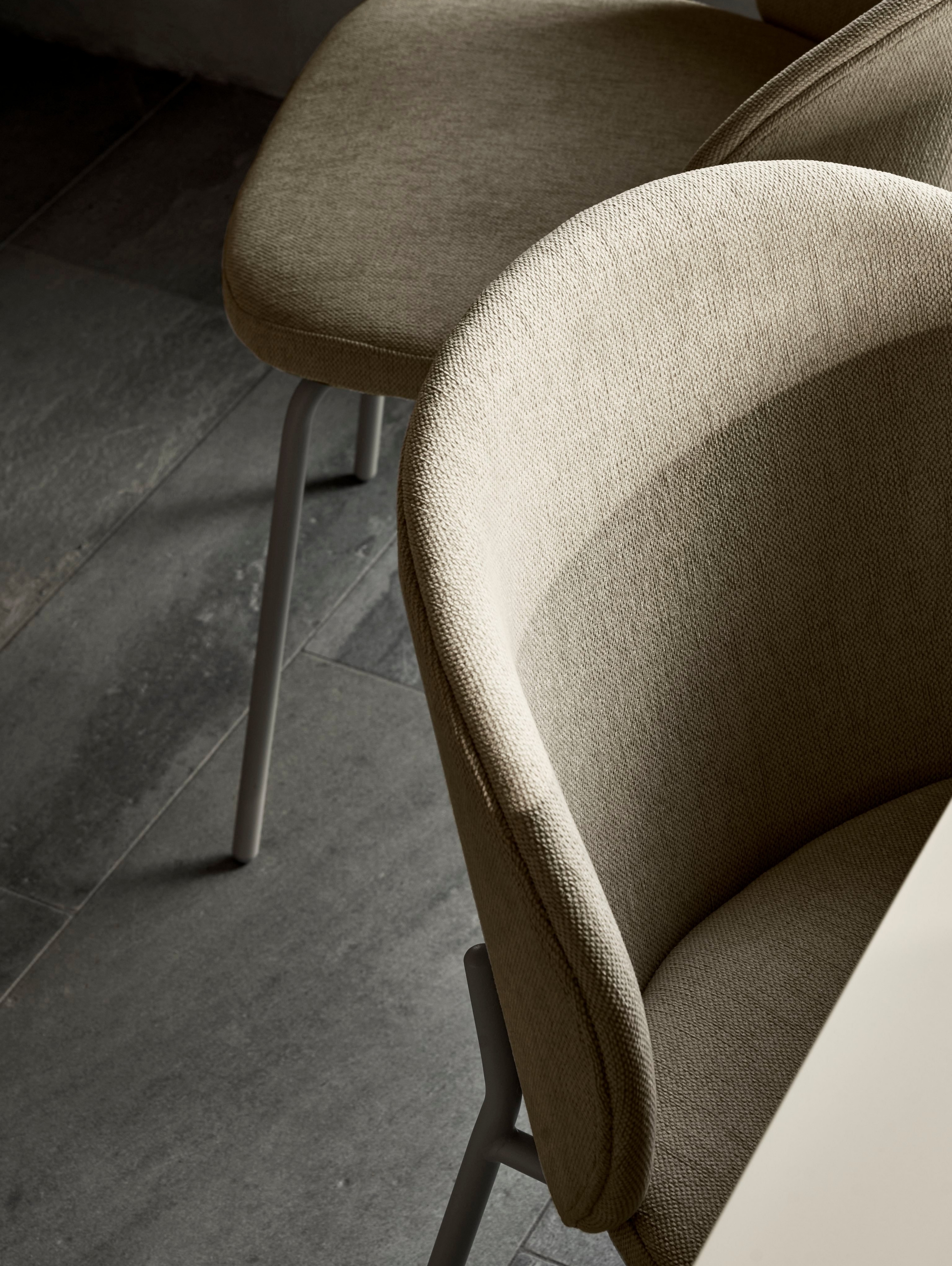 A close-up look at the Princeton dining chair in green Bresso fabric.
