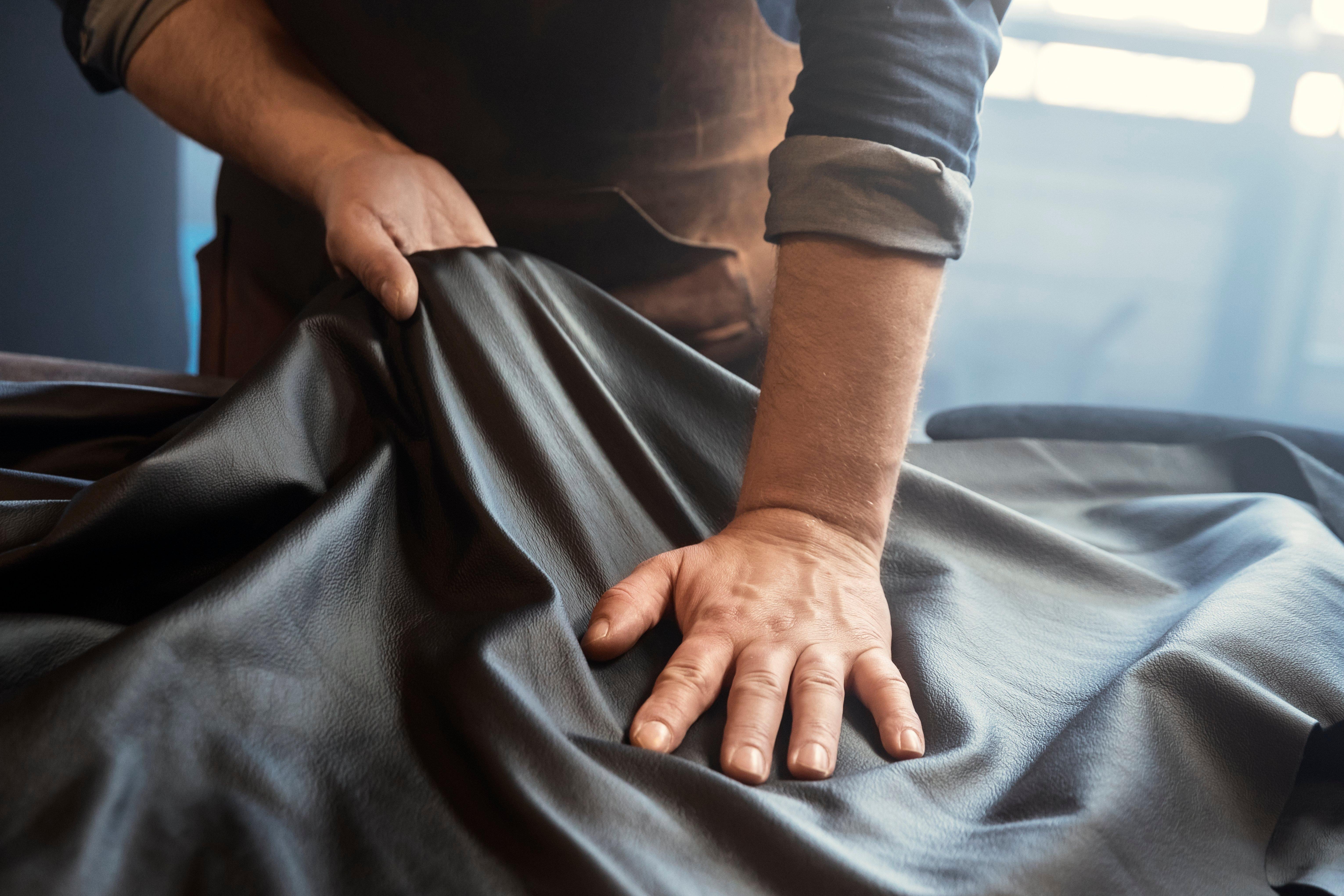 Up close of man working with leather in his hands 