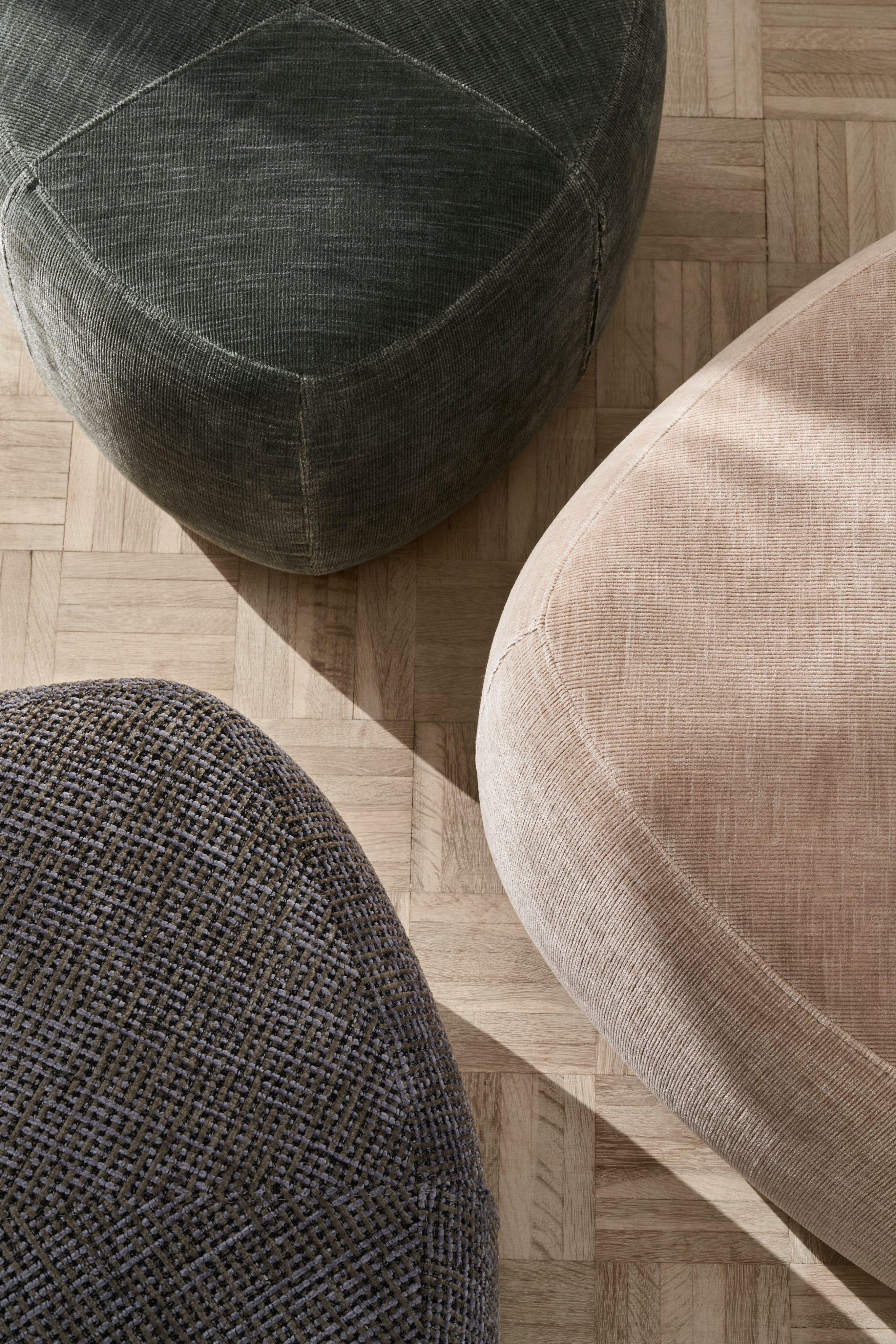 A collection of three Bermuda footstools in a variety of fabrics and colours.