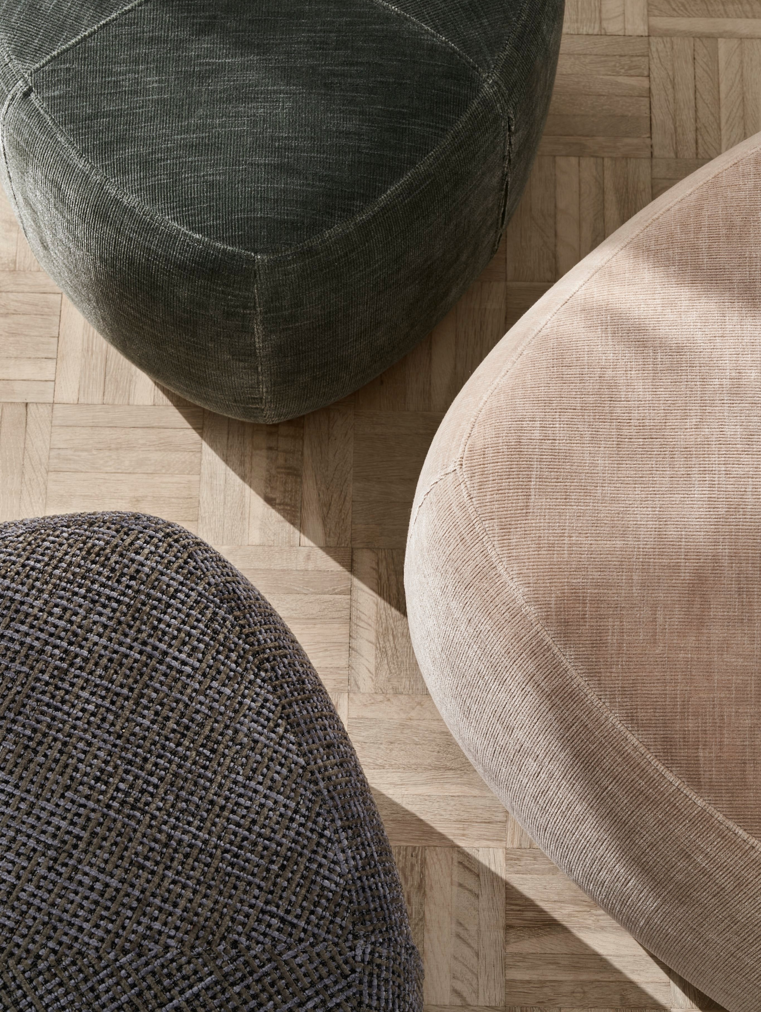A collection of three Bermuda footstools in a variety of fabrics and colours.