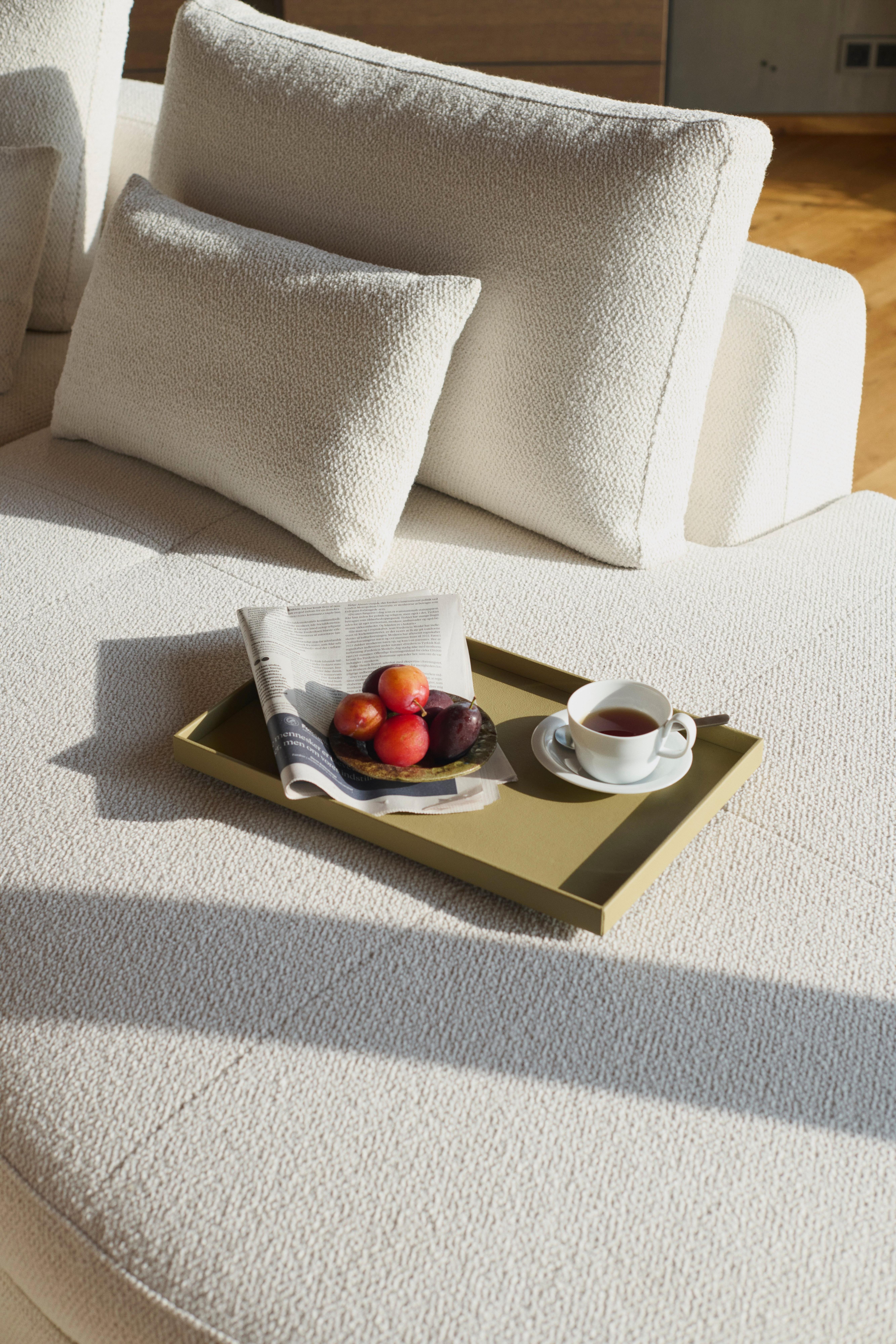 Image of the Bergamo sofa with round lounging unit in white Lazio fabric, with the Bergamo deco cushions in white Lazio fabric