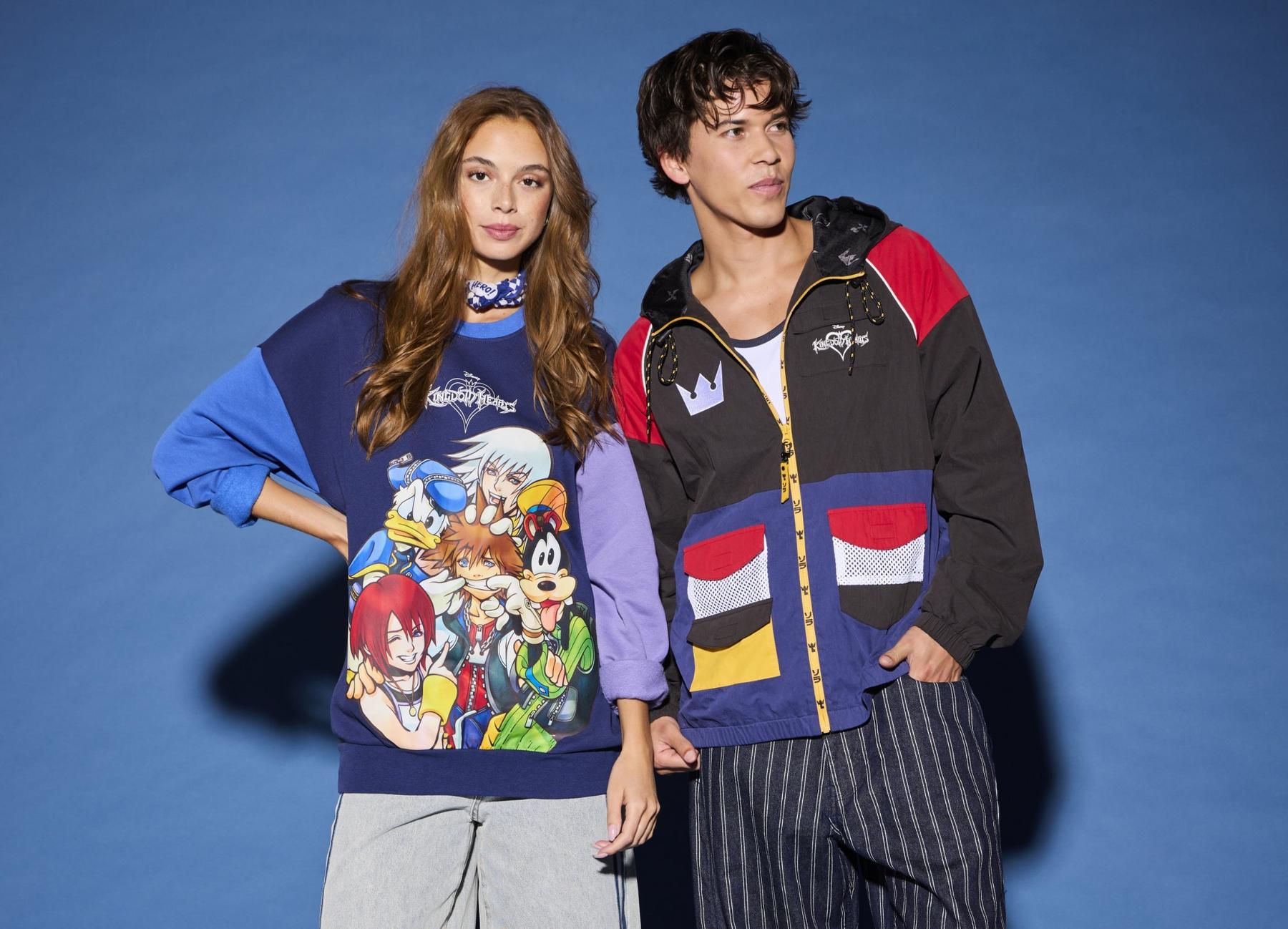 Two models wearing Disney Kingdom Hearts graphic sweatshirt and colorblock hooded jacket. Shop Now.