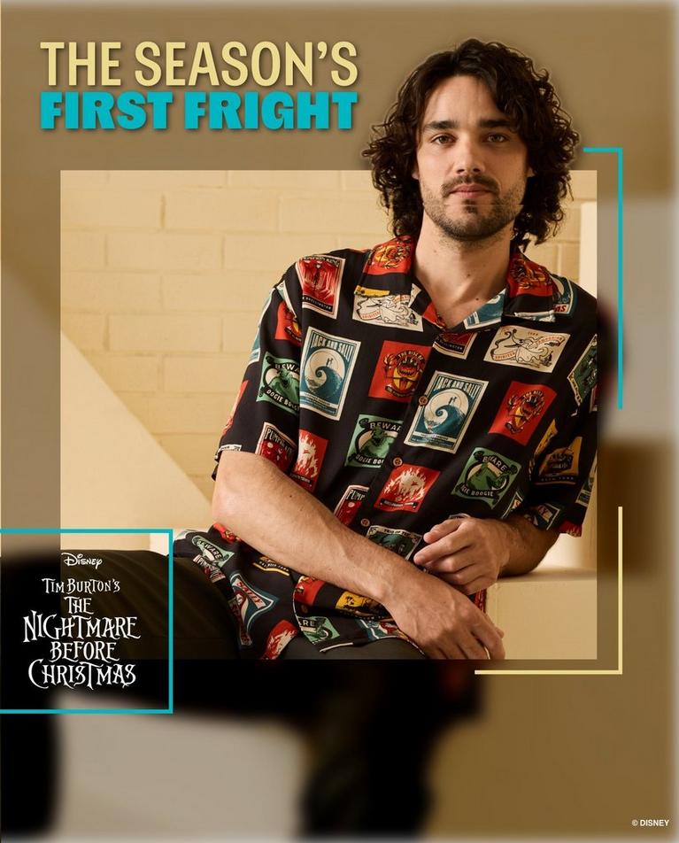 Model wearing Disney Tim Burton’s The Nightmare Before Christmas print button-up shirt. Shop Now.