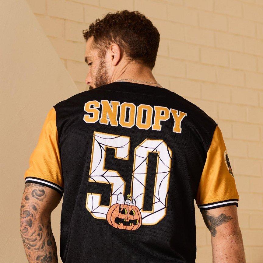 Back view of male model wearing black and gold jersey with "Snoopy 50" on the back. Shop Now.