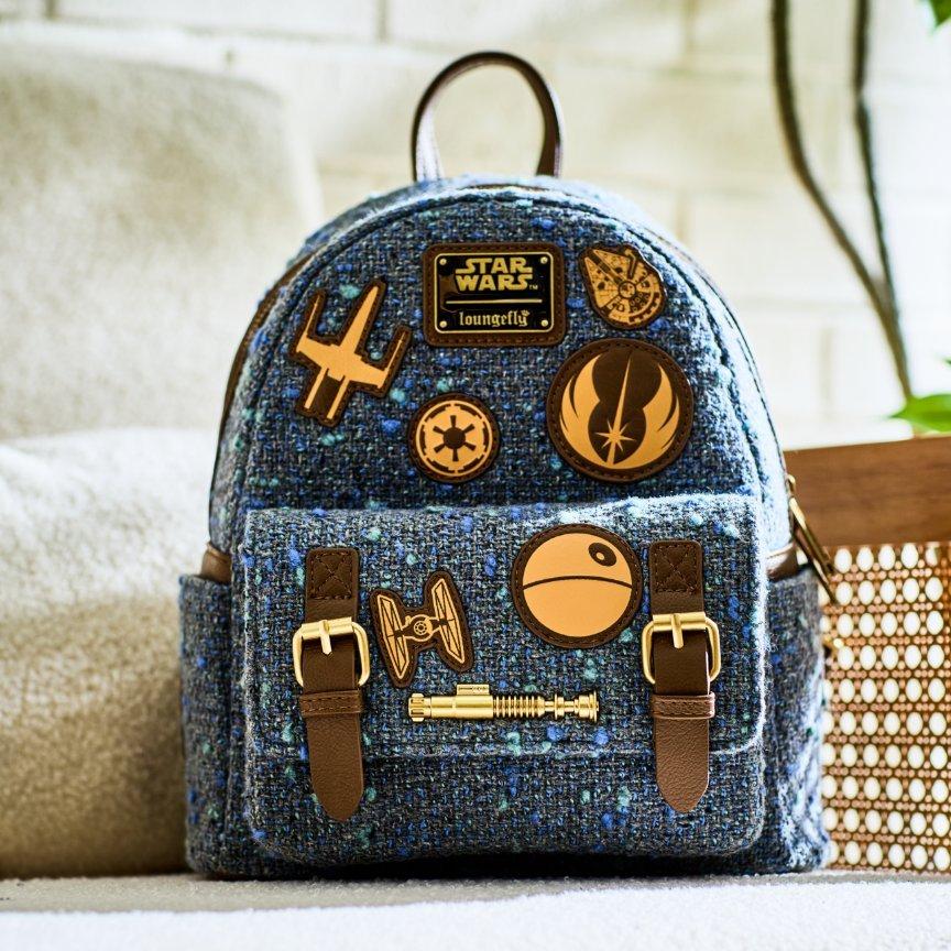 Blue Loungefly Star Wars mini backpack with character badges and front pocket with buckles. Shop Now.