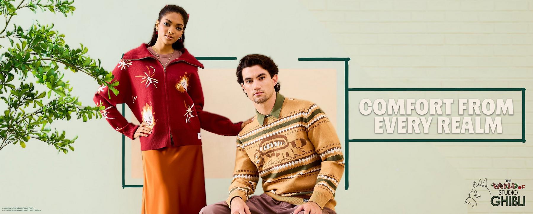 Two models wear Studio Ghibli knit sweater and zip cardigan; text reads “COMFORT FROM EVERY REALM”. Shop Now.