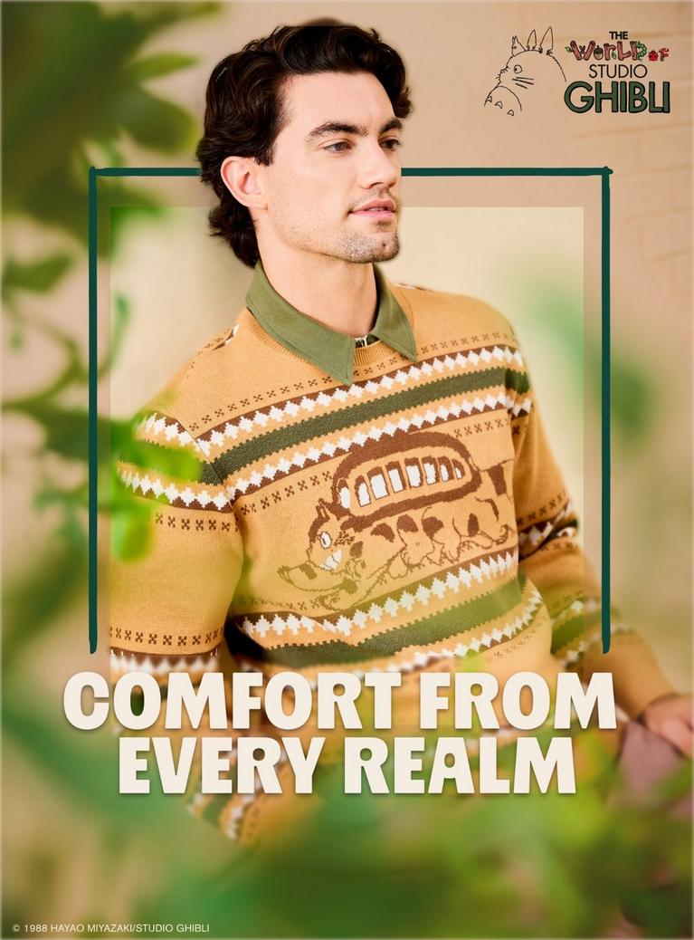 Model wearing a Studio Ghibli Totoro sweater, with text “COMFORT FROM EVERY REALM”. Shop Now.