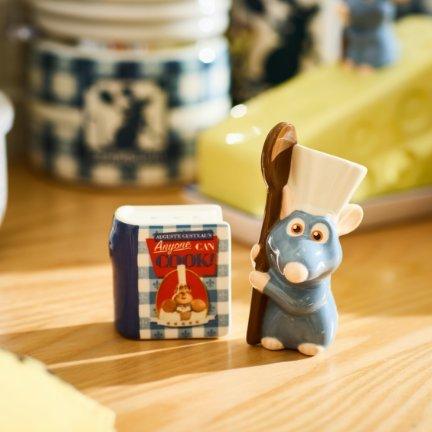 Disney Ratatouille Remy chef figurine holding spoon next to Anyone Can Cook jar.