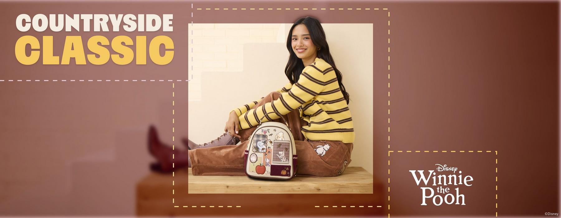Model wearing Disney Winnie the Pooh mini backpack with character patches and plaid details. Shop Now.