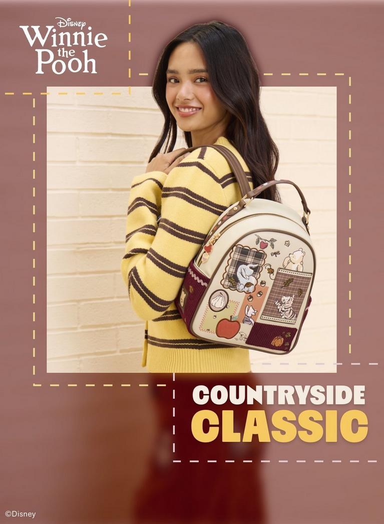Model wearing Disney Winnie the Pooh mini backpack with character patches and plaid details. Shop Now.