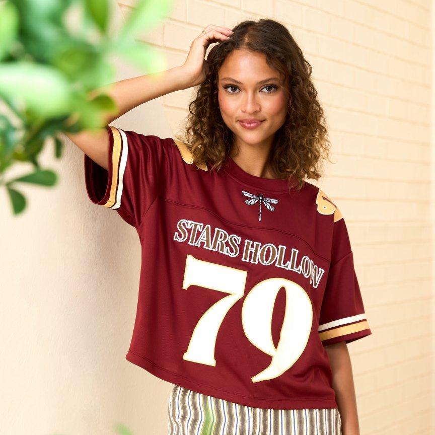 Model wearing burgundy Stars Hollow 79 jersey top. Shop Now.