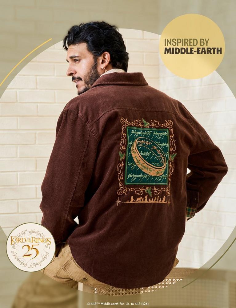 Man wearing brown jacket with embroidered Lord of the Rings ring design on back. Shop Now.