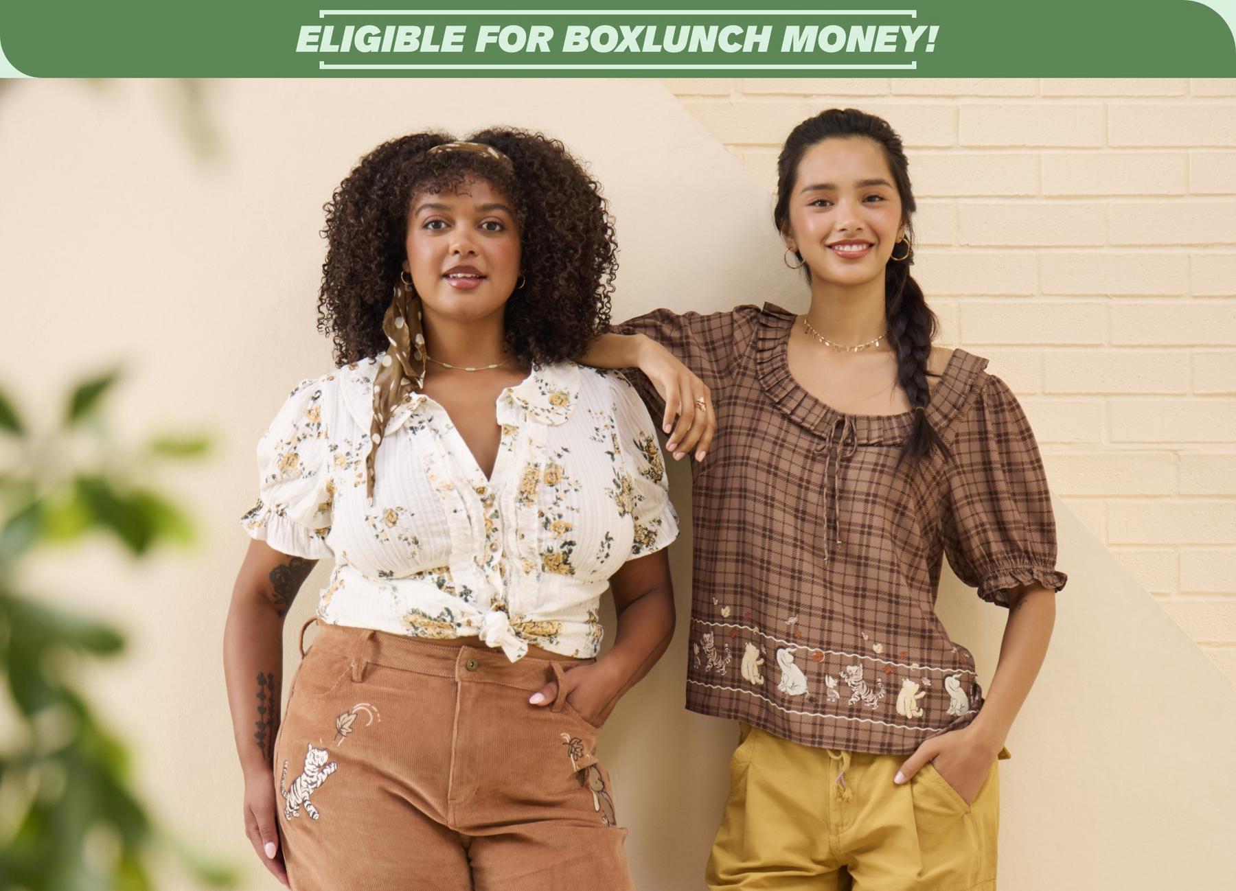 Models wearing brown embroidered Winnie the Pooh pants and a brown plaid Winnie the Pooh blouse under “ELIGIBLE FOR BOXLUNCH MONEY!” banner. Shop Now.