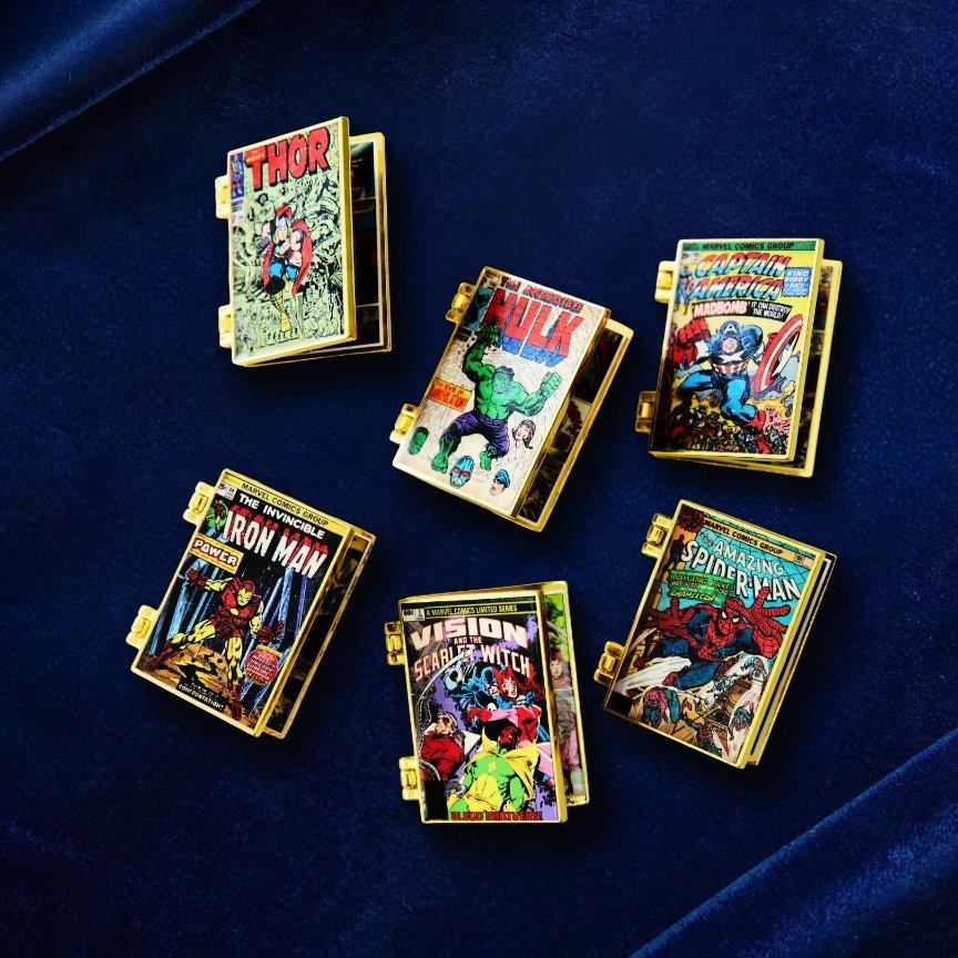 Gold-tone comic book cover charms featuring Thor, Hulk, Captain America, Iron Man, Vision, and Spider-Man. Shop Now.