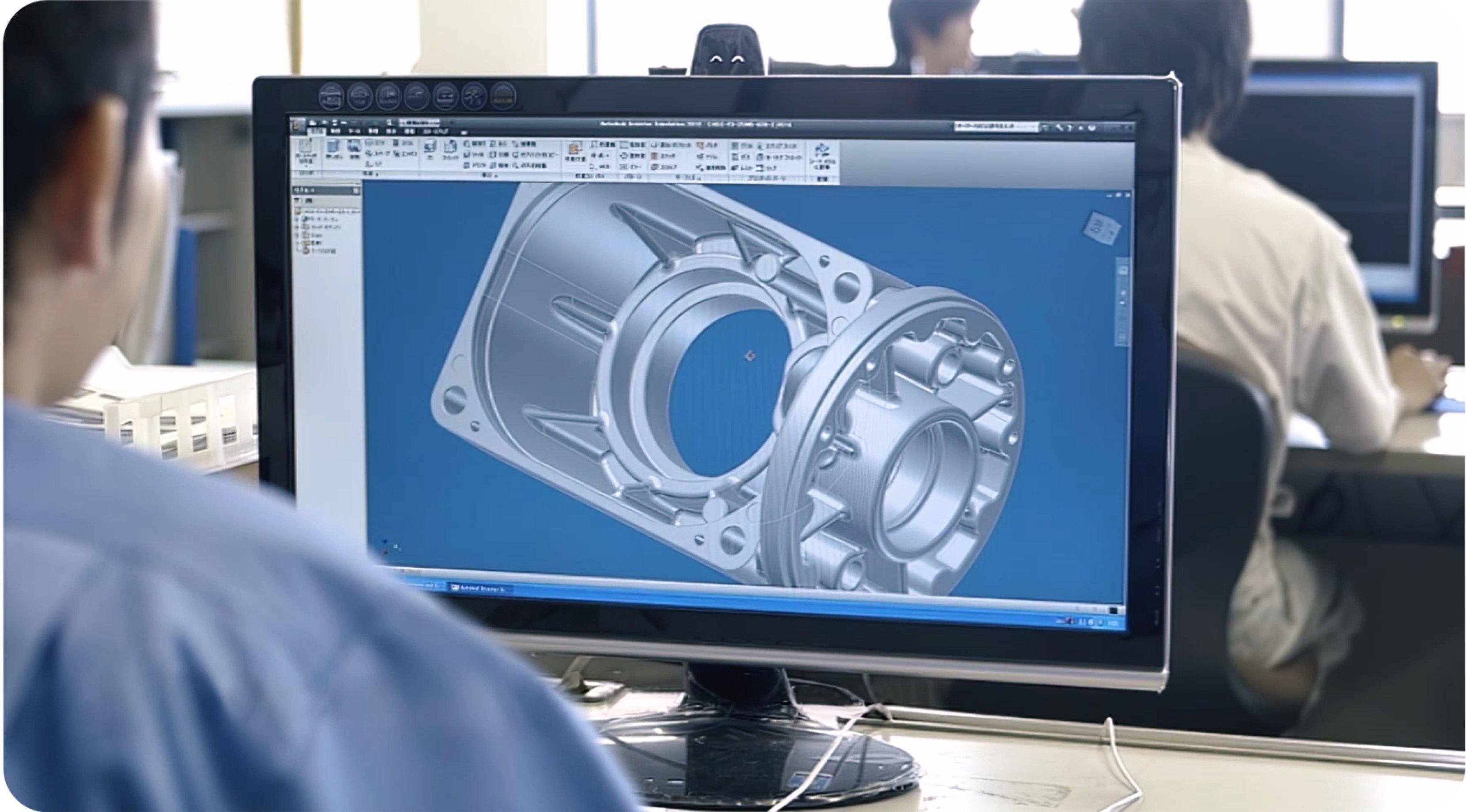 Engineer working on a computer with a gearmotor file. 