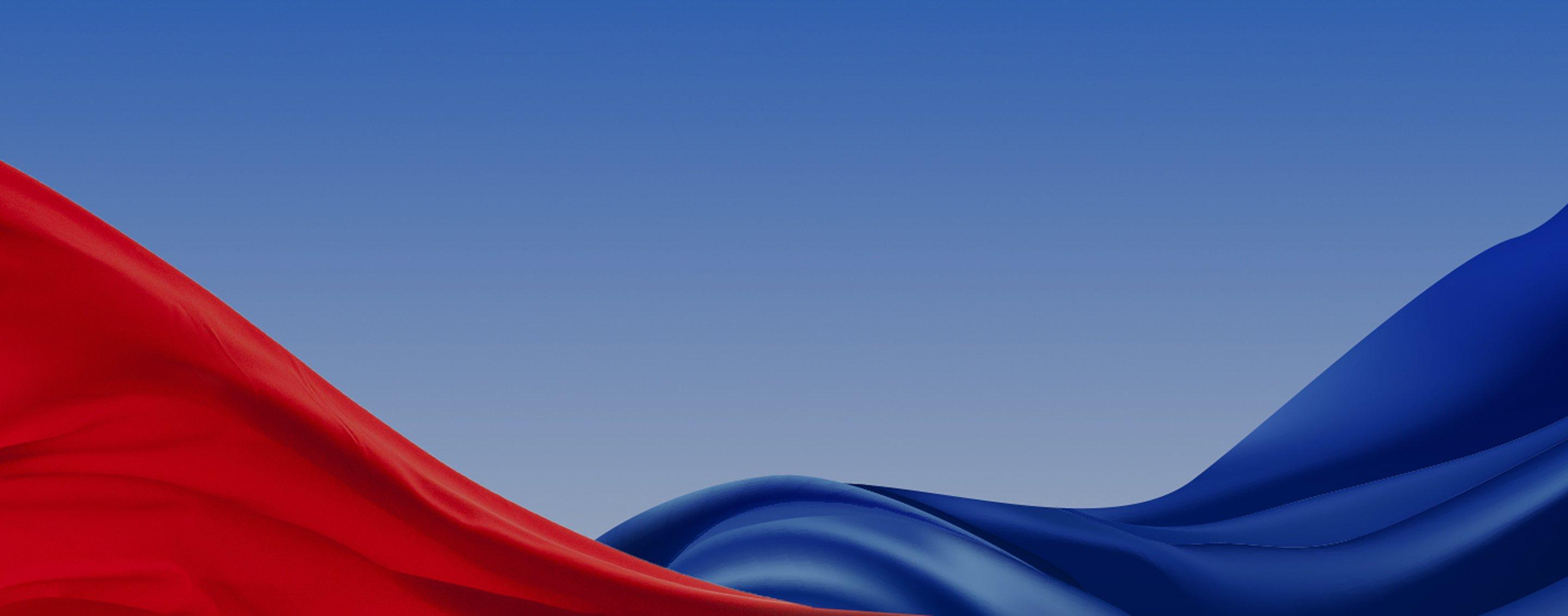 Abstract red and blue flowing fabric-like waves against a light blue gradient background.
