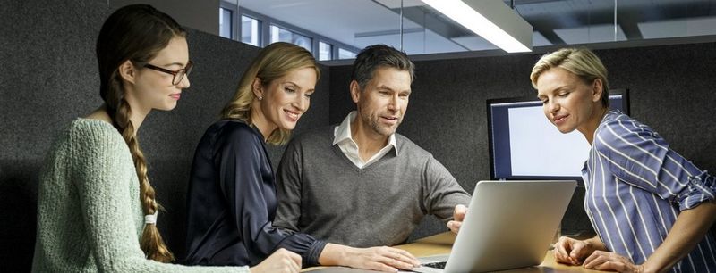 Colleagues with laptop in meeting box