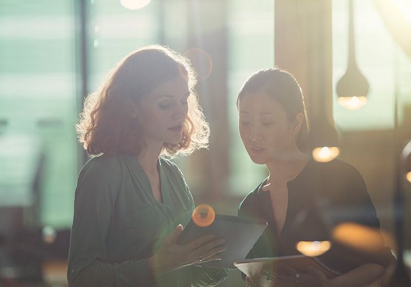 Two women looking at a tablet