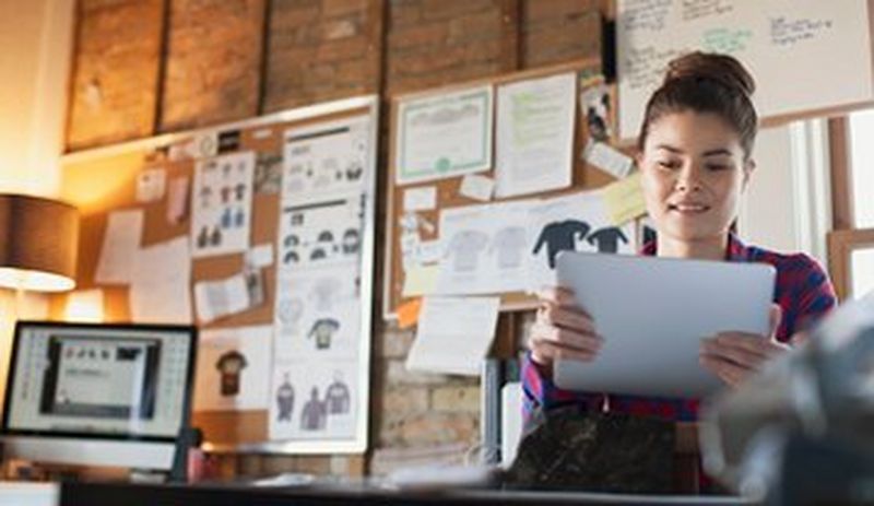 Female in office with paper in hands