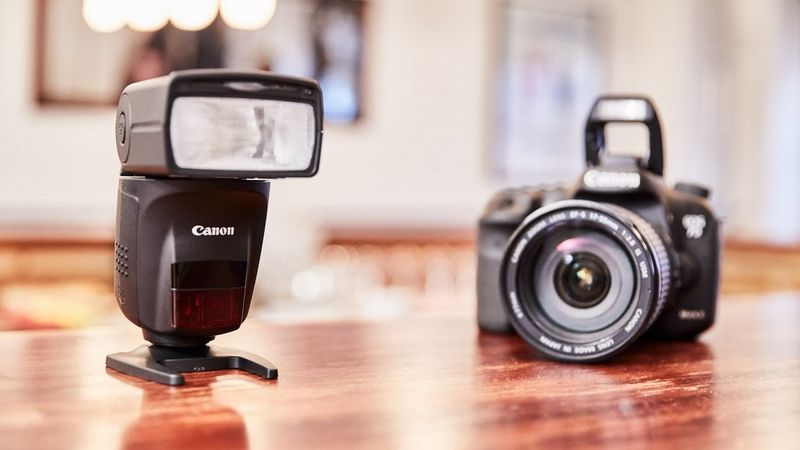 Canon 6D Mark II and Canon Speedlite 470EX-AI on a brown table