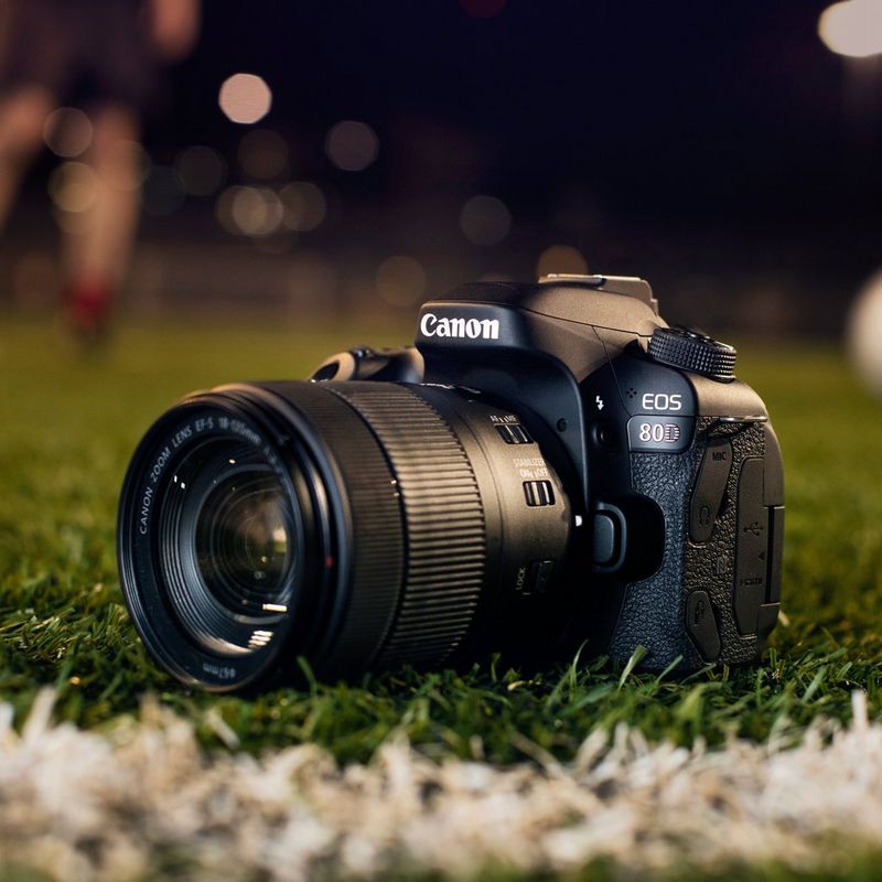 Canon EOS 80D + 18-135mm IS USM Objektiv Kamera auf einem Sportplatz mit verschwommenem Hintergrund
