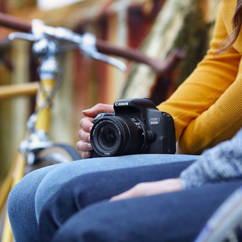 Canon EOS 800D + EF-S 18-55mm 1:4-5,6 IS STM Kamera, die im Schoß abgelegt ist